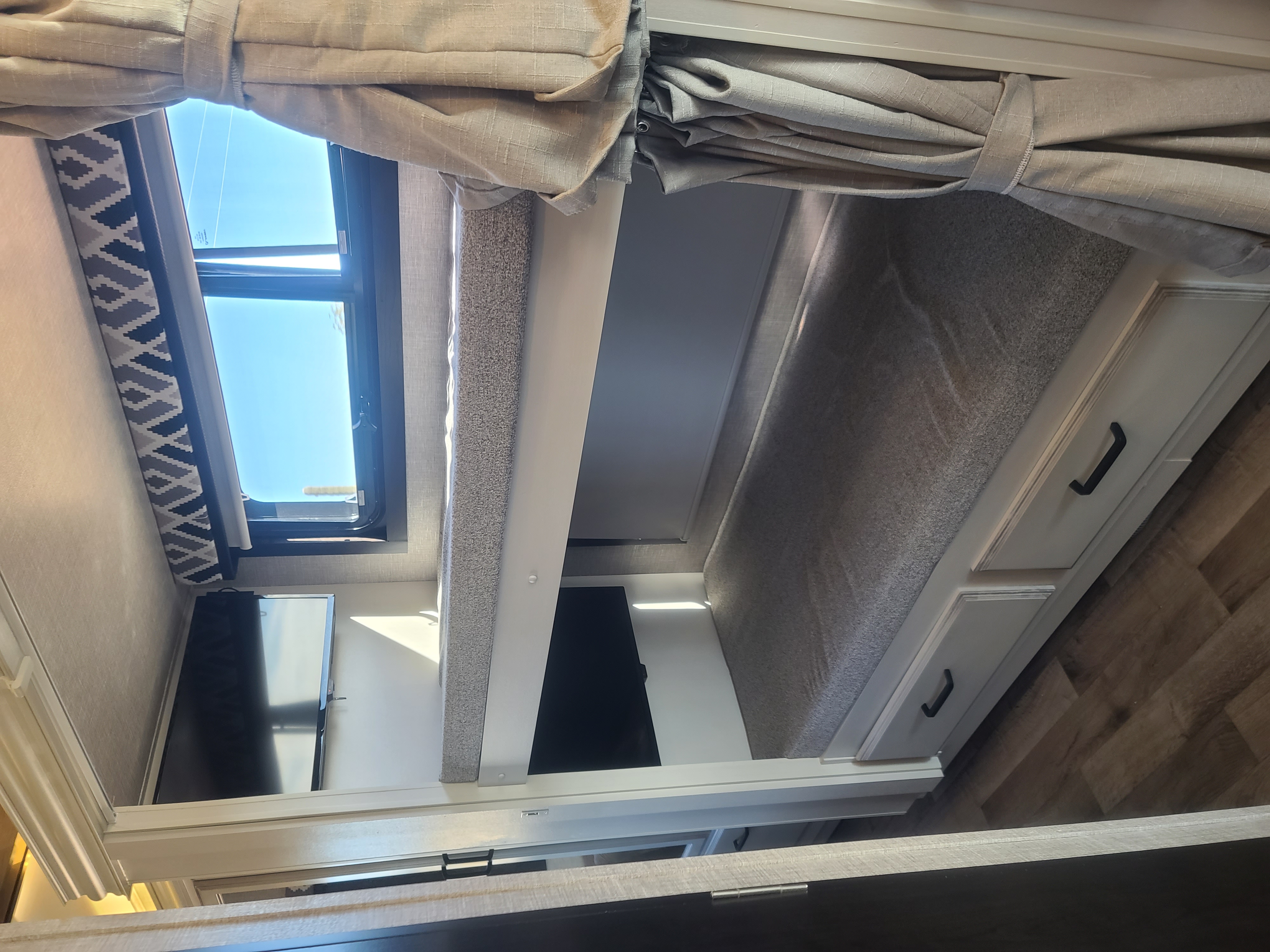 Cozy RV rental interior featuring modern bunk beds with built-in storage and individual TVs.. Entegra Vision 29F 2022