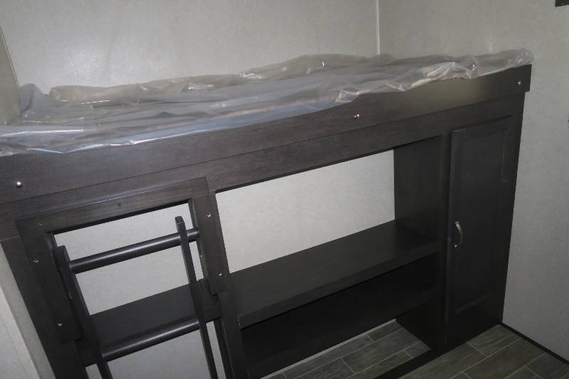 New RV rental bunk beds feature a mattress in plastic, built-in shelves, cabinet, and ladder access.. Palomino Puma 2018