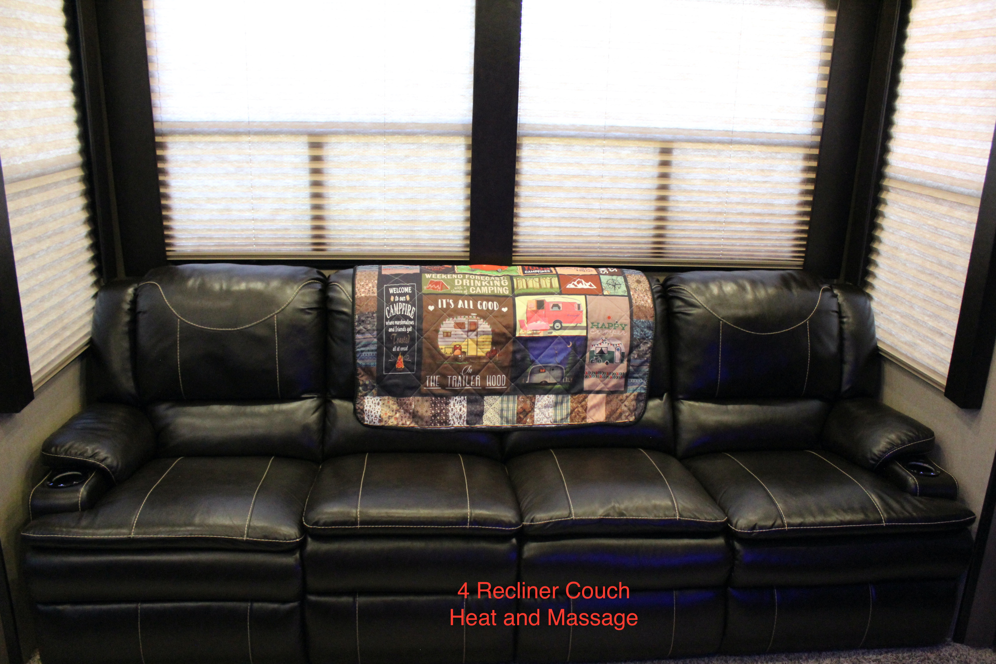 RV rental: Black 4-recliner couch with heat, massage, cup holders, and a cozy camping blanket.. Grand Design Momentum Toy Hauler 2016