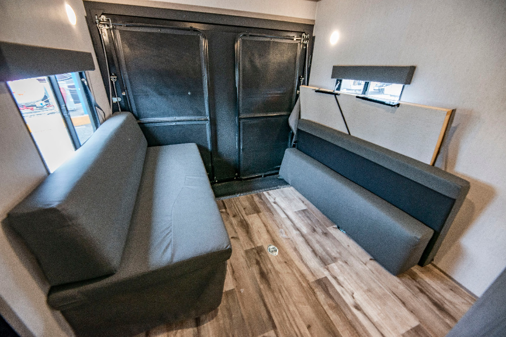 RV rental interior features convertible sofas & rear ramp/doors for flexible space. Wood floor and versatile living/cargo area.. Coleman Lantern 300tq 2022