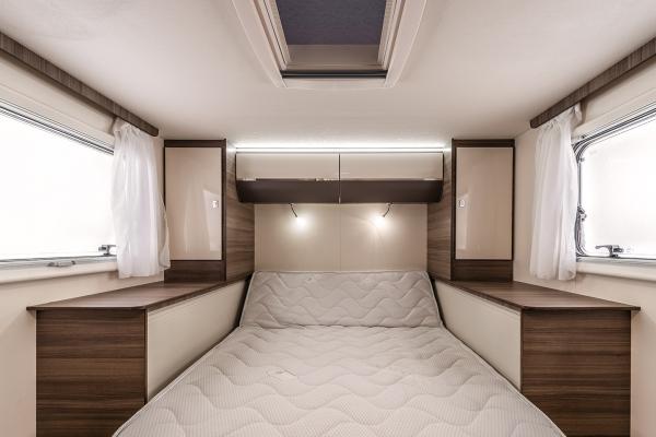 Inside a comfortable RV rental: A spacious bedroom with a large bed, ample storage, and natural light from wide windows.. Wallace Wallace 2020