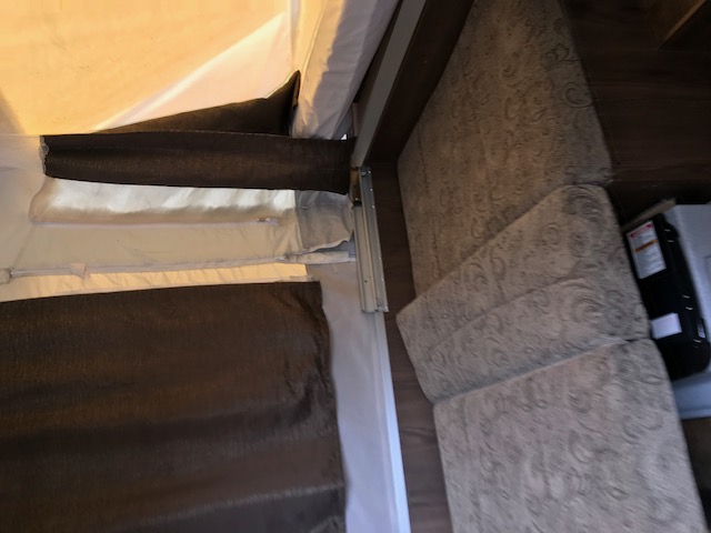 RV rental interior: View of a pop-up camper bunk with privacy shades and patterned lounge seating.. Forest River Other 2017