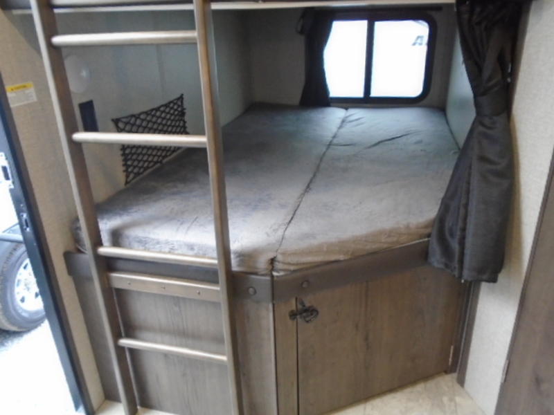 RV rental bunk beds: cozy sleeping area with ladder, window, and under-bed storage for comfortable travel.. Jayco Jay Flight 2020