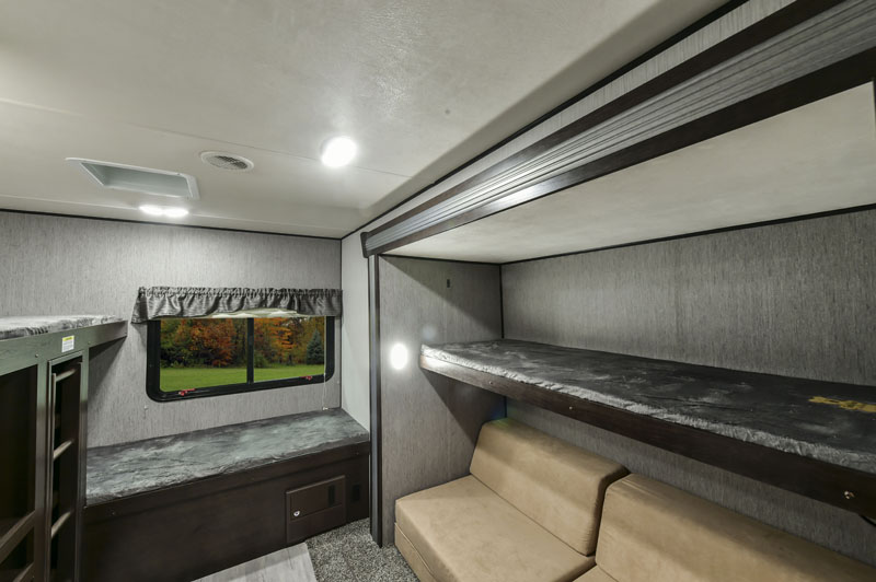 RV rental interior: a comfortable living and bunk space with window views, ideal for family travel.. Heartland RVs Prowler 2020