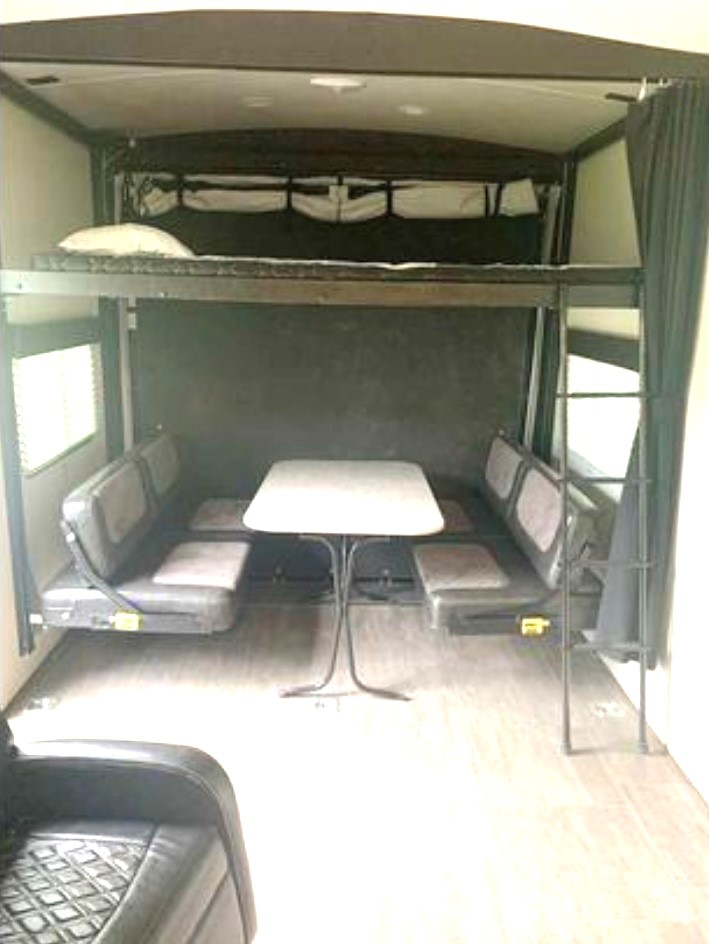 RV rental: Versatile interior featuring a bunk bed above a convertible dinette and a spacious utility area.. Cruiser Rv Corp Stryker 2018
