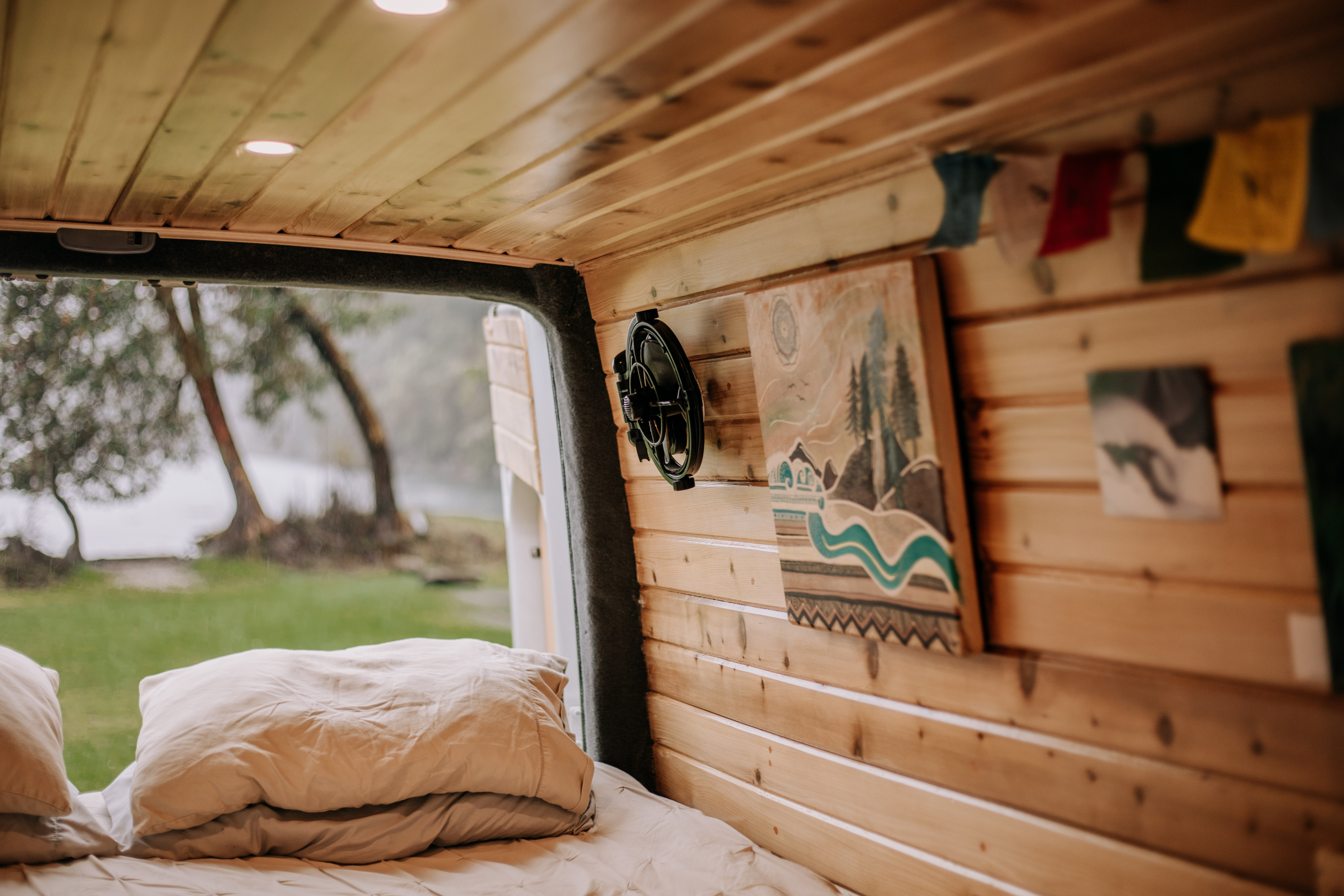 Cozy RV rental interior with bed and scenic nature view from the back, perfect for van life adventures.. Dodge Sprinter Van 2007