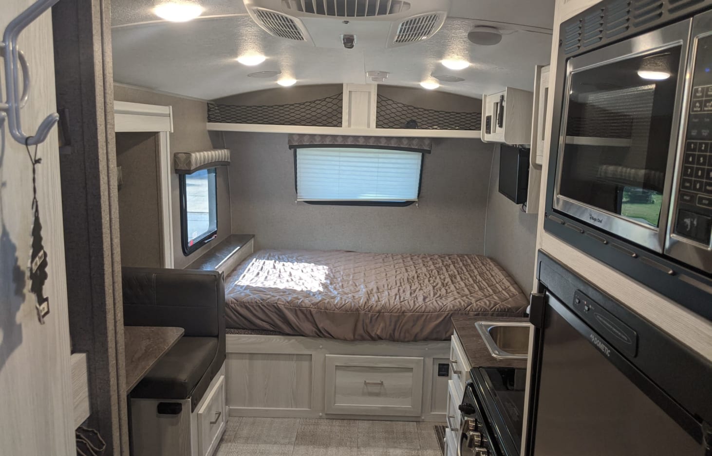 Experience comfort in this rv rental. Features include a cozy bed, dinette, and compact kitchen with microwave and fridge.. Forest River Other 2021