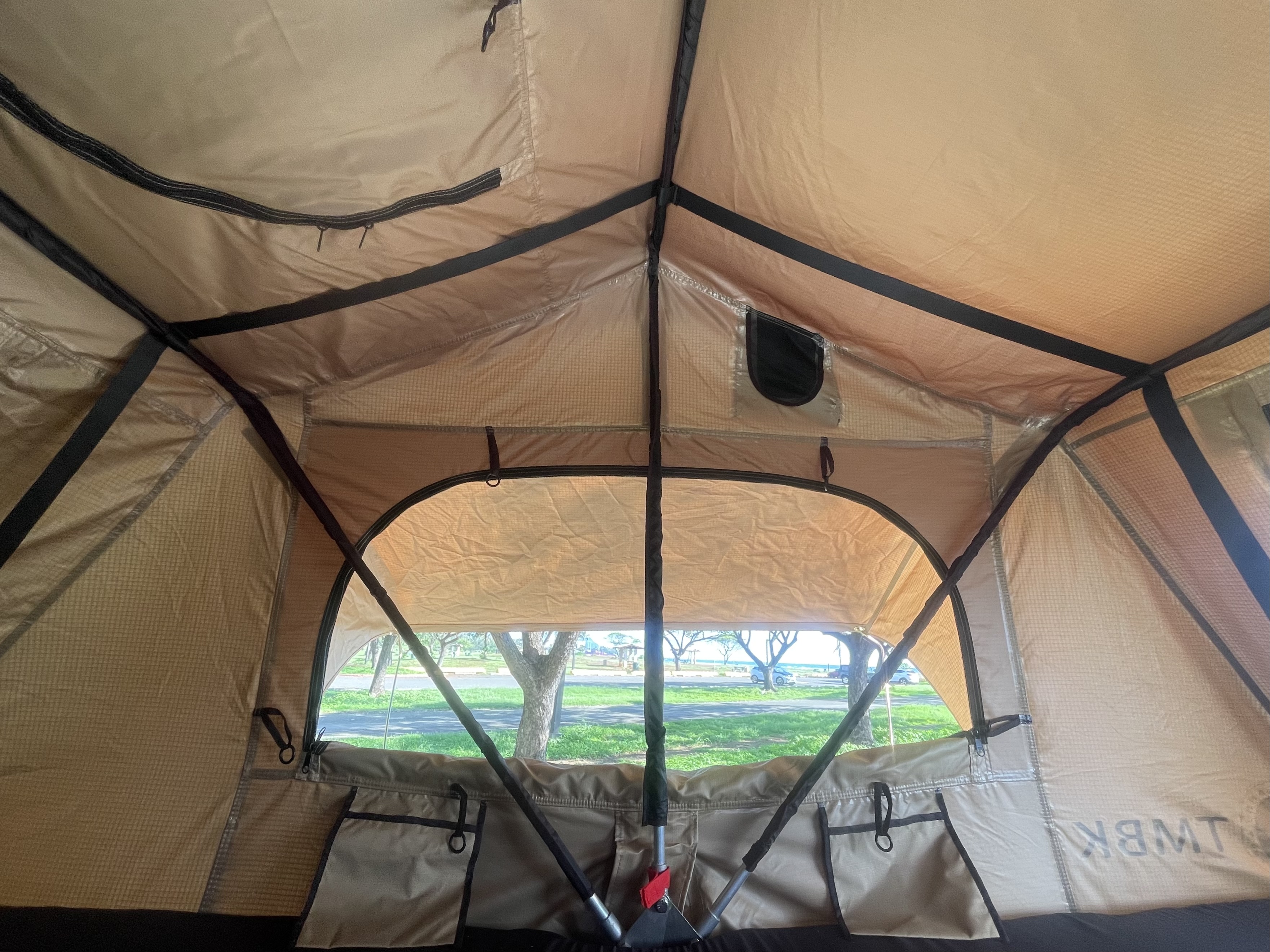 Inside an RV rental tent, looking out at the ocean, road, and trees from the campsite. Enjoy spacious outdoor living!. Toyota Tacoma 2005