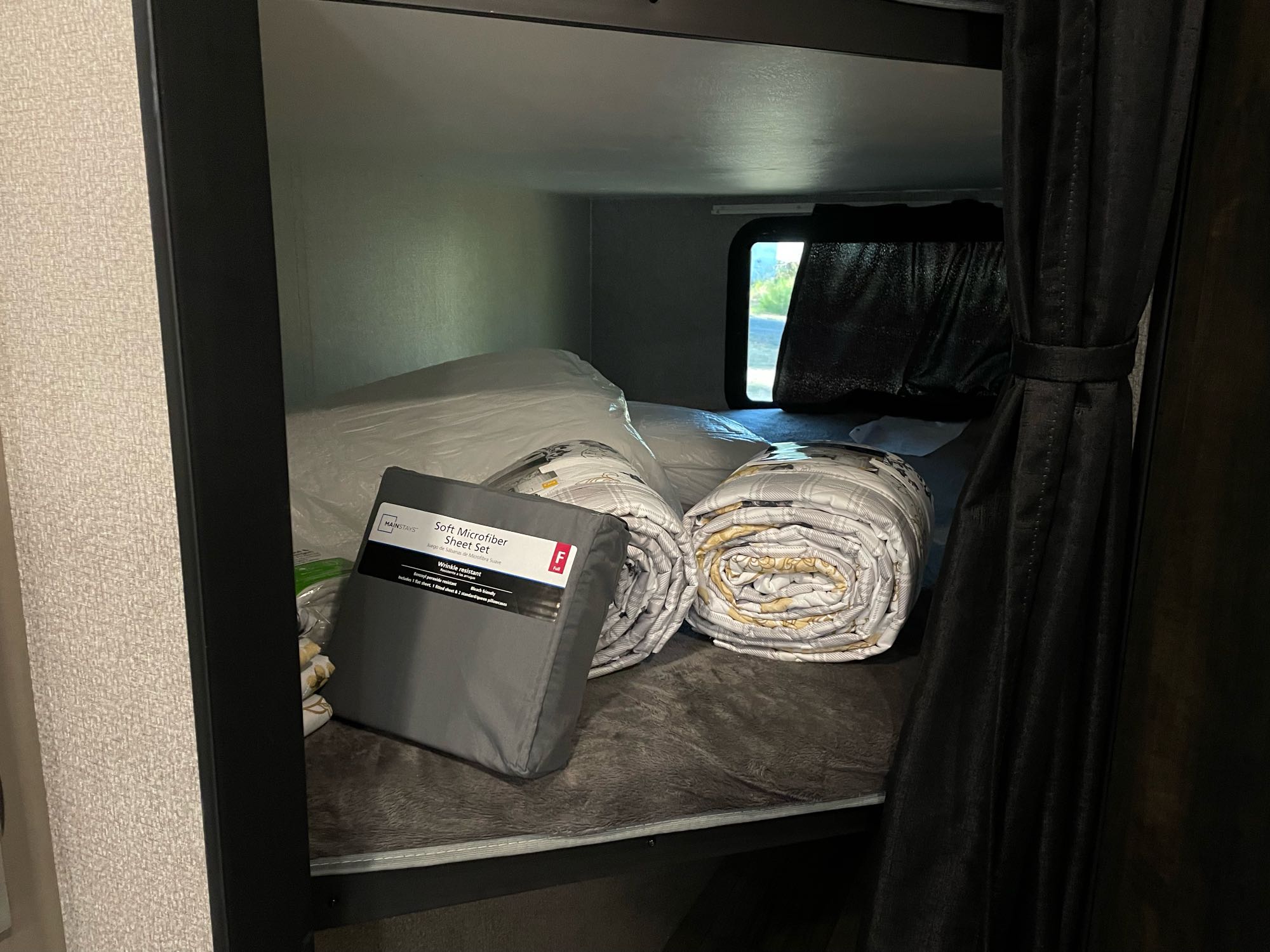 New bedding for an rv rental: Soft microfiber sheets and rolled comforters on a bunk bed, ready for travel.. Highland Ridge Mesa Ridge 2021