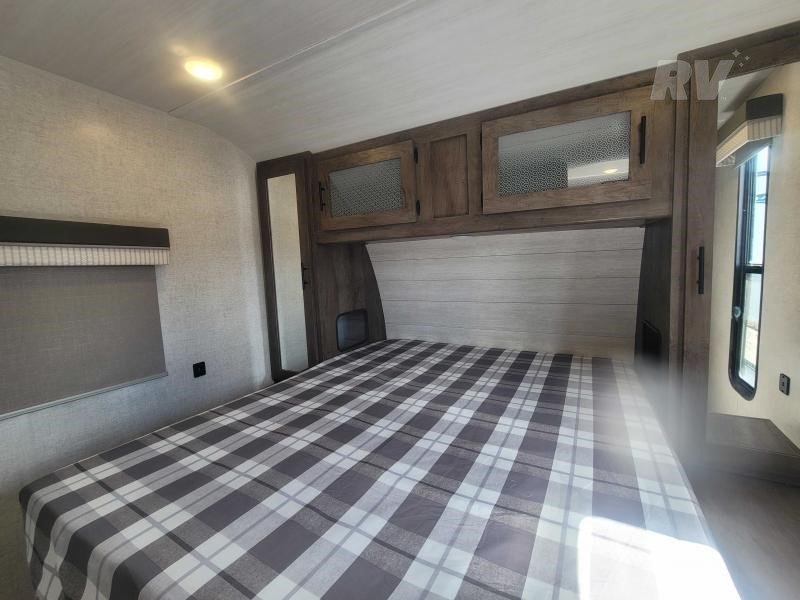 Queen size bed and two closets with underbed storage. Forest River Salem 2021