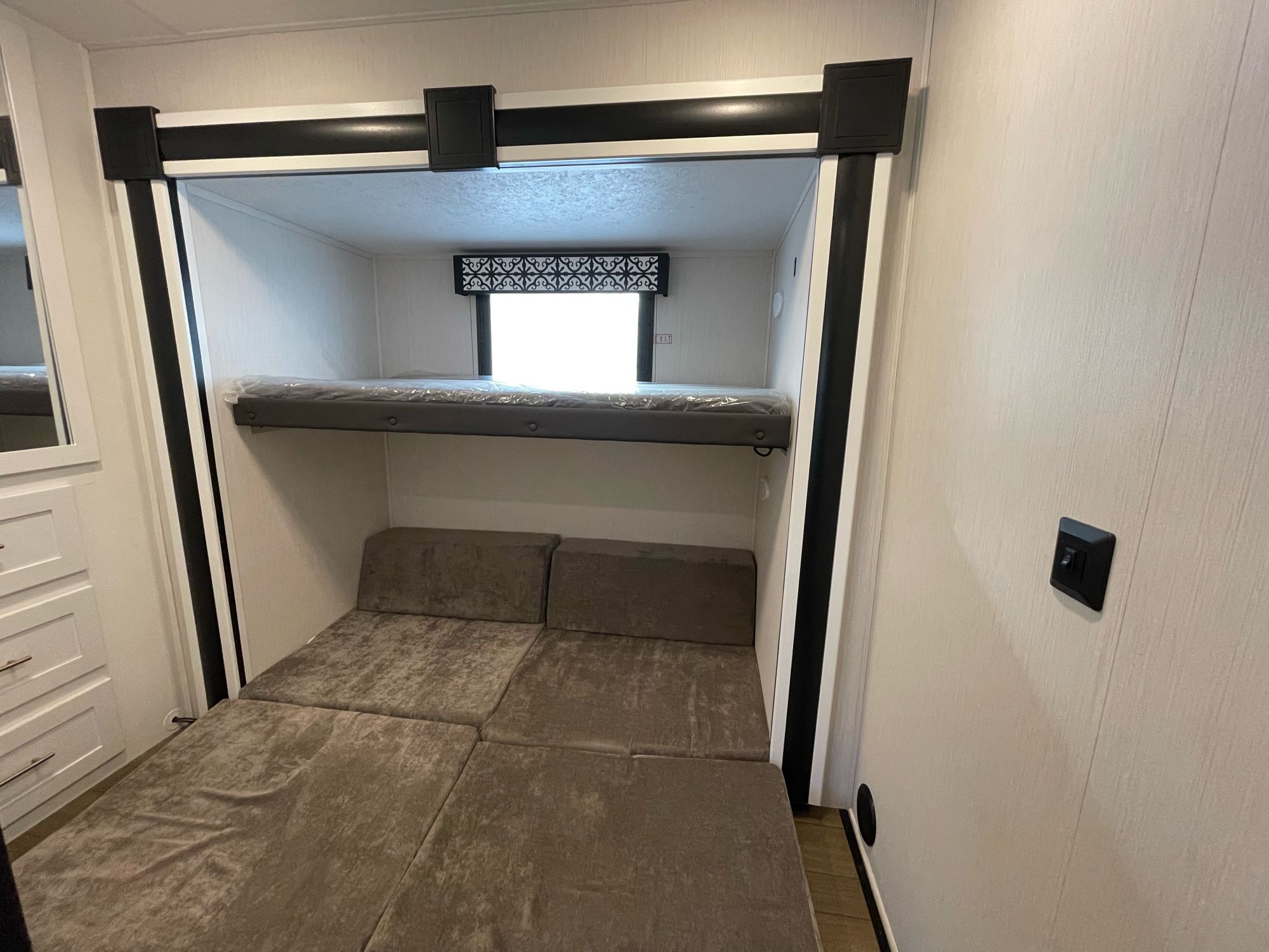 This RV rental features a comfortable bunk bed over a versatile convertible sofa/bed, optimizing space for family adventures.. Forest River 303MBX 2022