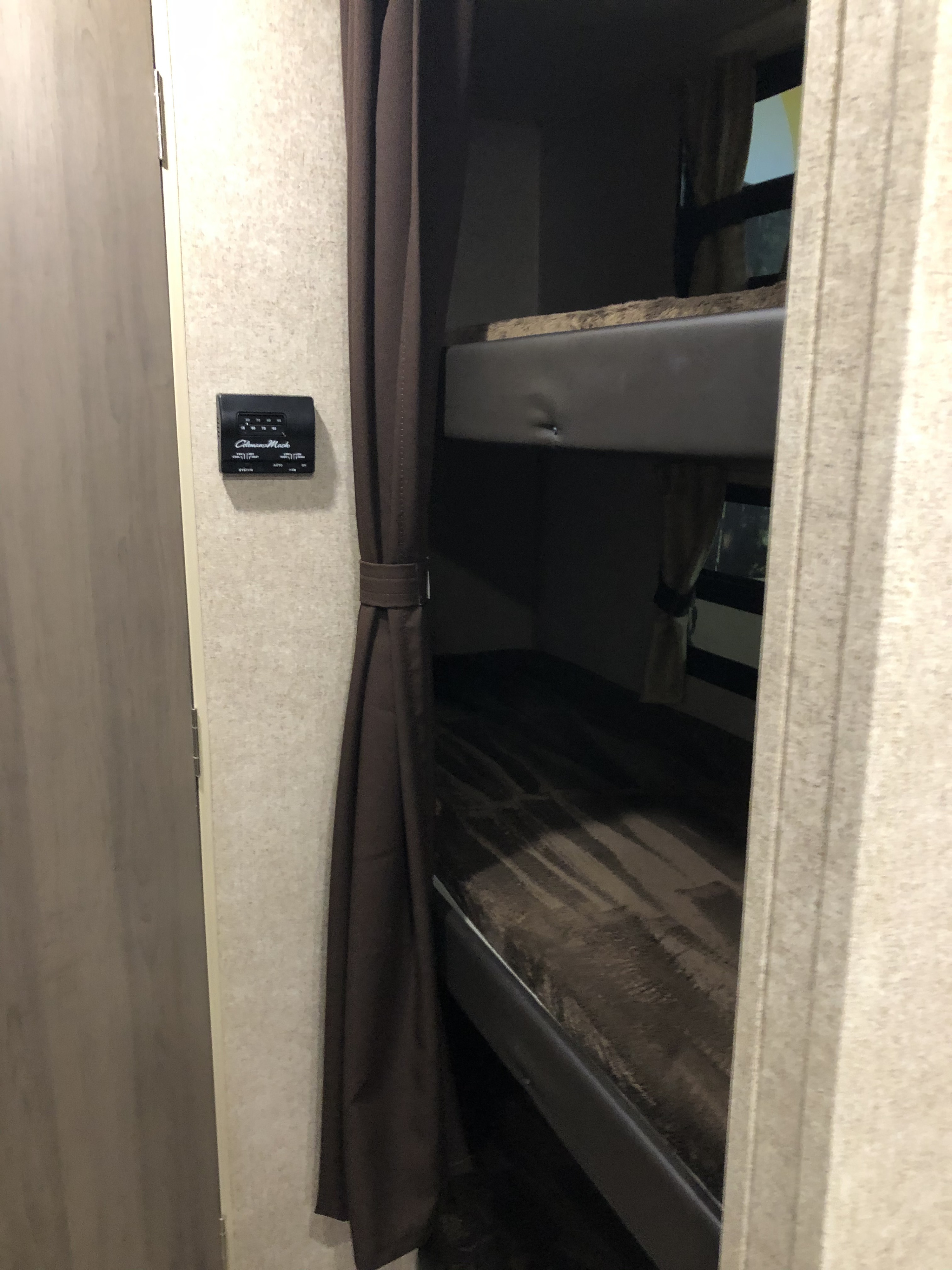 RV rental bunk beds: a cozy sleeping area with privacy curtain & Coleman-Mach thermostat for climate control.. Coachmen Catalina SBX 221TBS 2019