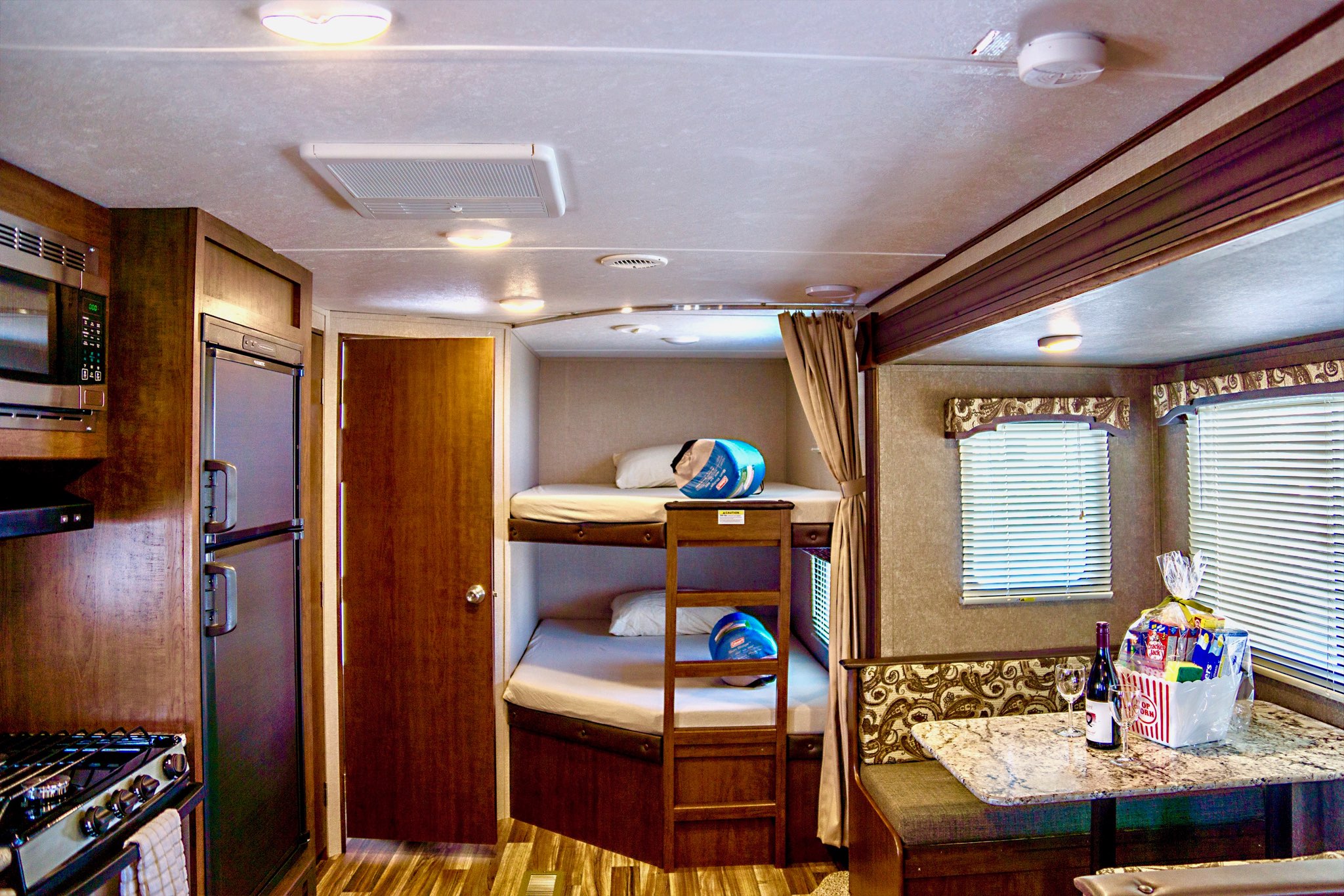 Spacious rv rental interior with kitchen, bunk beds, and dining area, ready for your adventure.. Keystone Hideout 2018