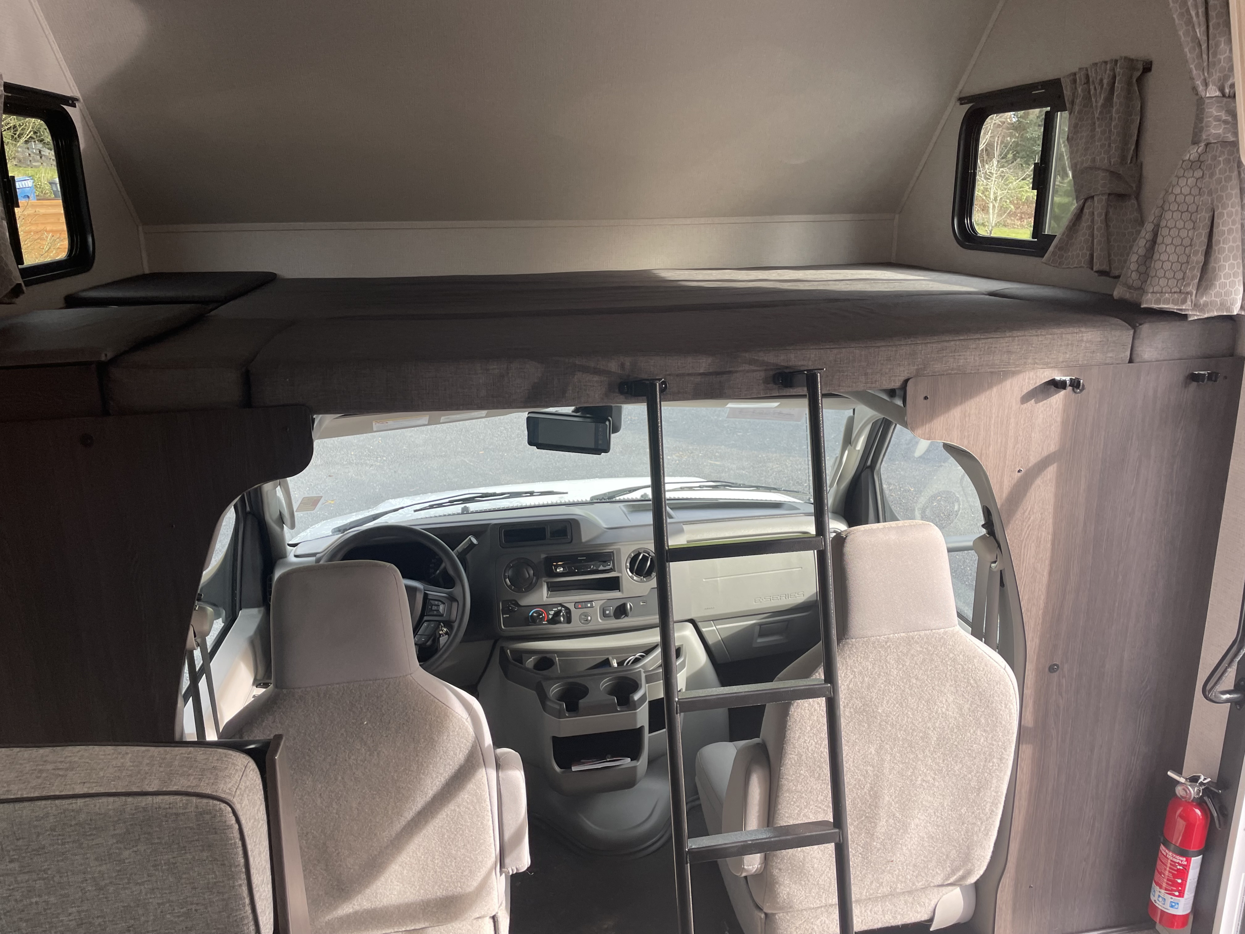 Overhead Loft: Queen Size sleeping area, with in floor storage and power. Forest River Sunseeker LE 2021