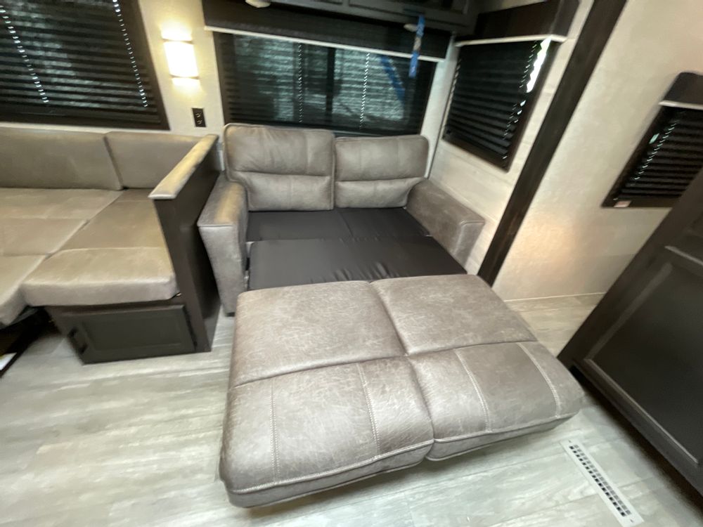 RV rental: Convertible sofa bed and dinette seating in a cozy RV interior, perfect for flexible living spaces.. Jayco Jay Flight 2022