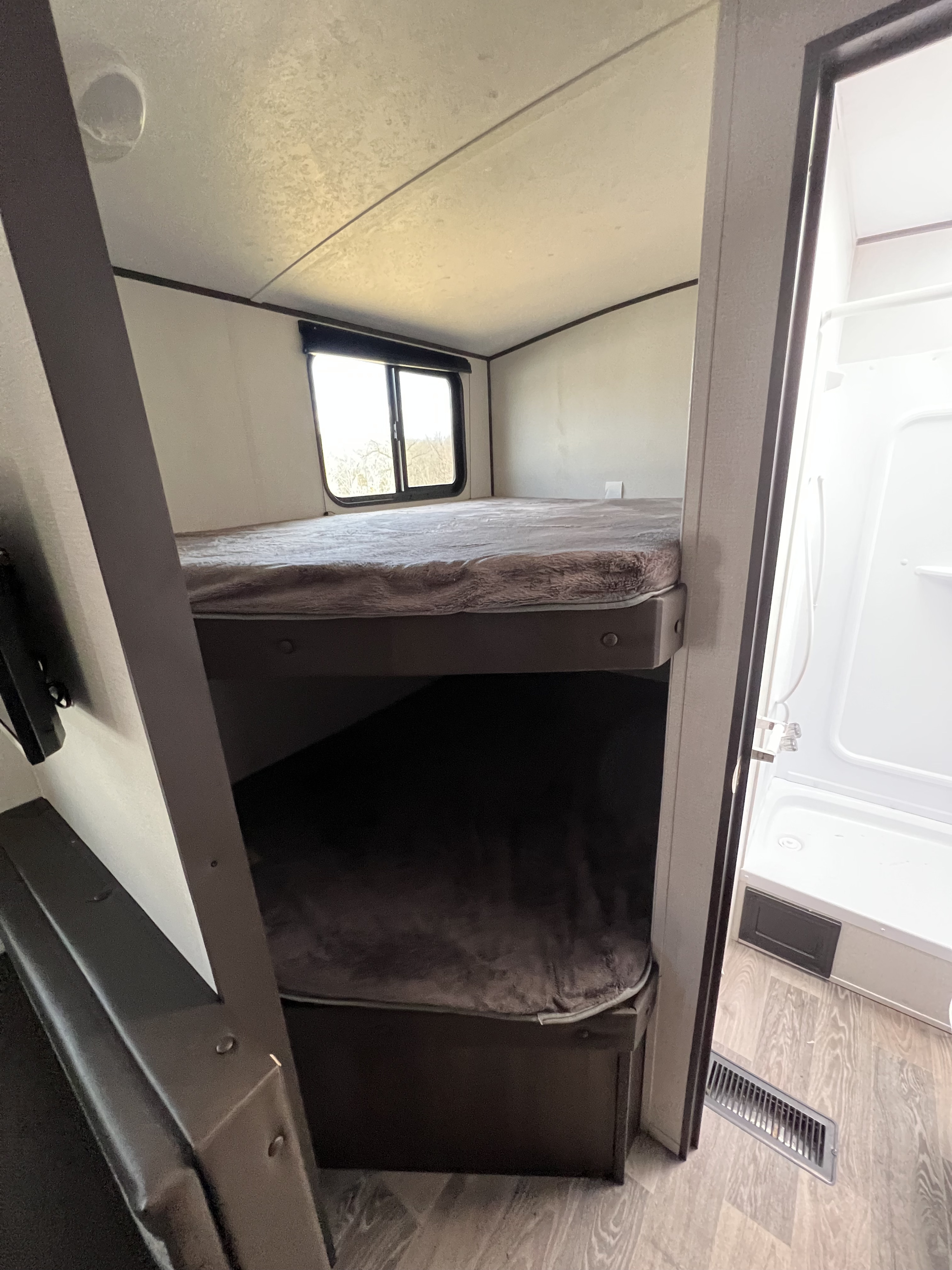 RV rental: Bunk beds & bathroom. This RV features two comfy bunks and a shower visible through the doorway.. Keystone Springdale 2020