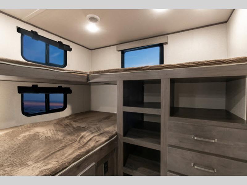 RV rental bunk bed area featuring windows, cozy sleeping, and built-in storage. Ideal for family adventures.. Grand Design 29tbs 2020