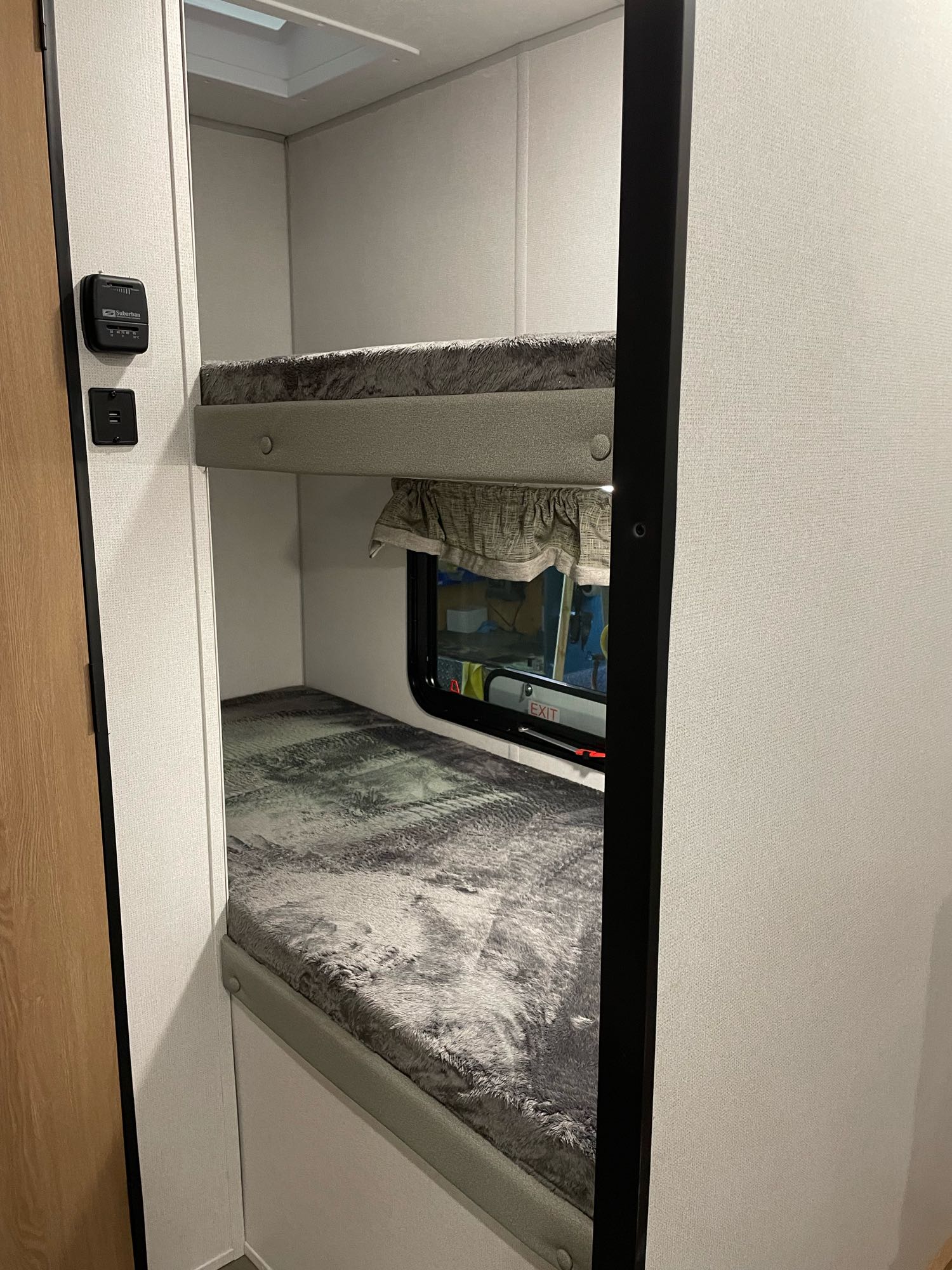RV rental bunk beds feature cozy sleeping areas with a window and thermostat.. Forest River 17Ft 2022
