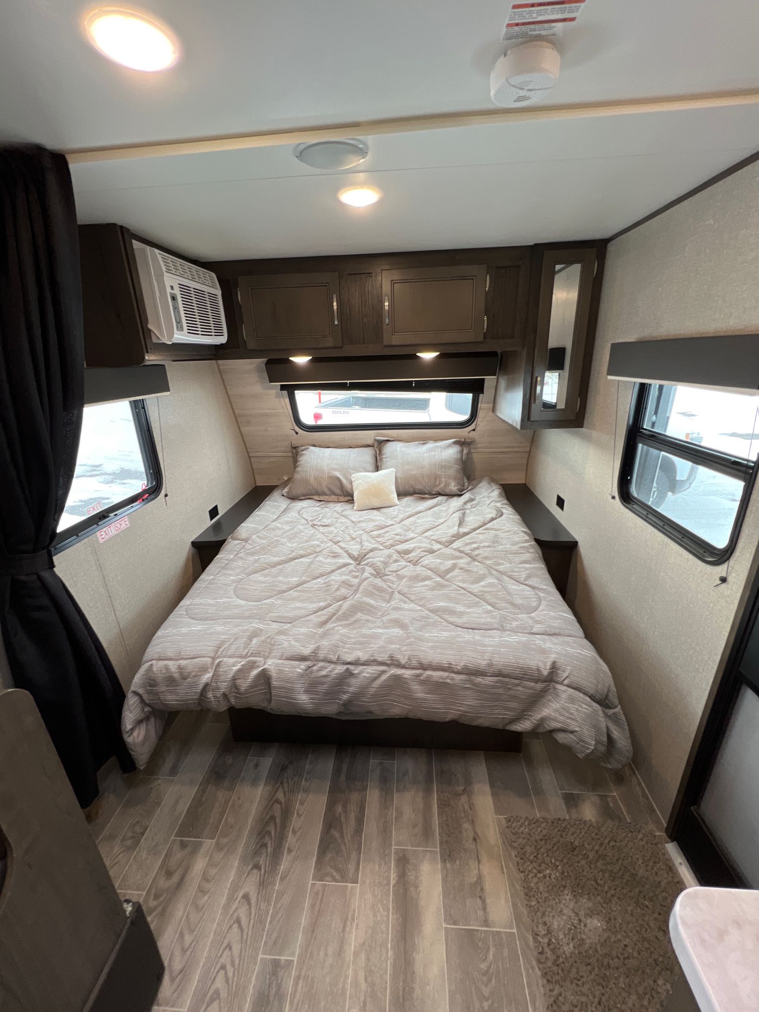 Relax in this cozy RV rental bedroom. Features a comfortable bed, ample storage, AC, and large windows for natural light.. Jayco Jay Flight SLX Baja Edition 2021