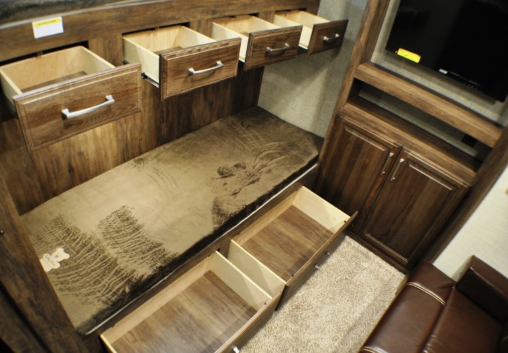 RV rental bunk bed with storage solutions: four overhead drawers & two under-bed drawers. TV & seating.. Keystone RV Cougar 2019