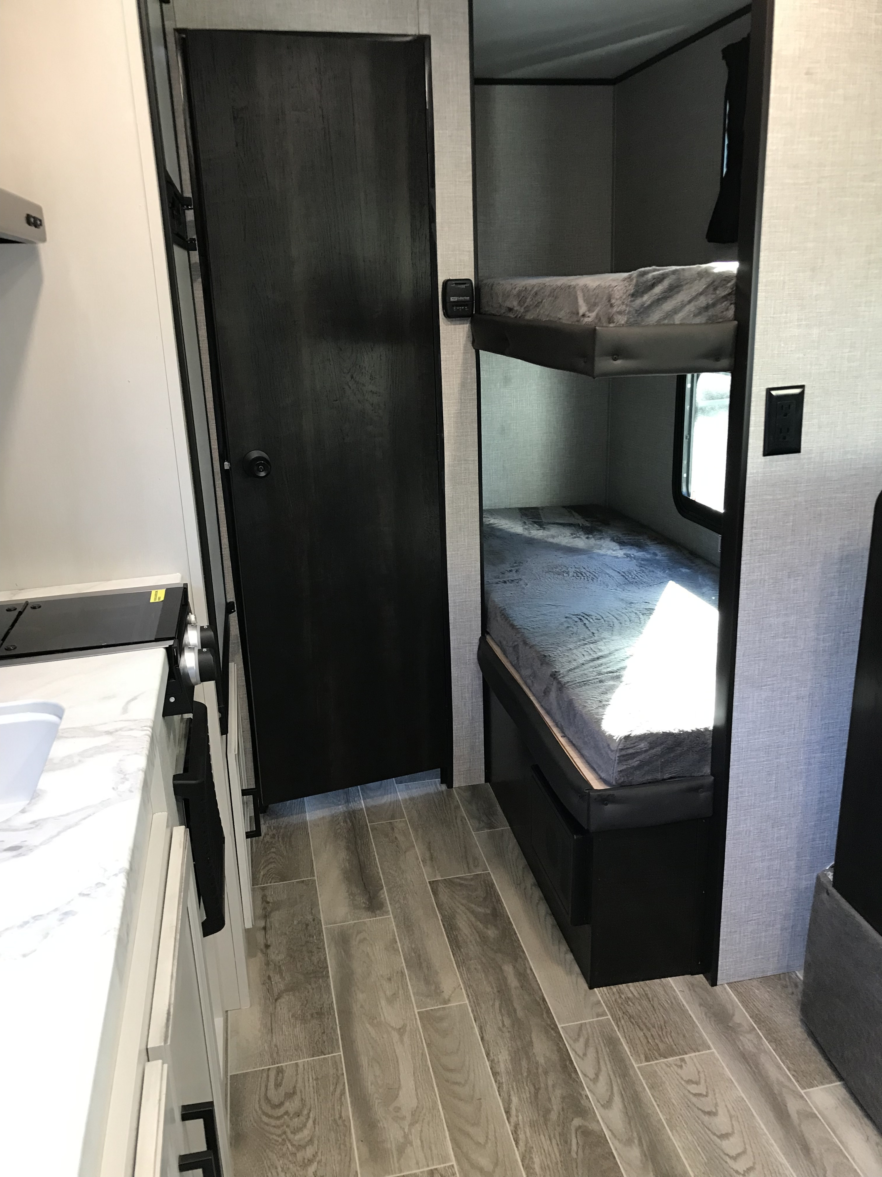 RV rental: kitchen counter, closed door, bunk beds. Efficient interior for comfortable travel.. Jayco Jay Flight 2022