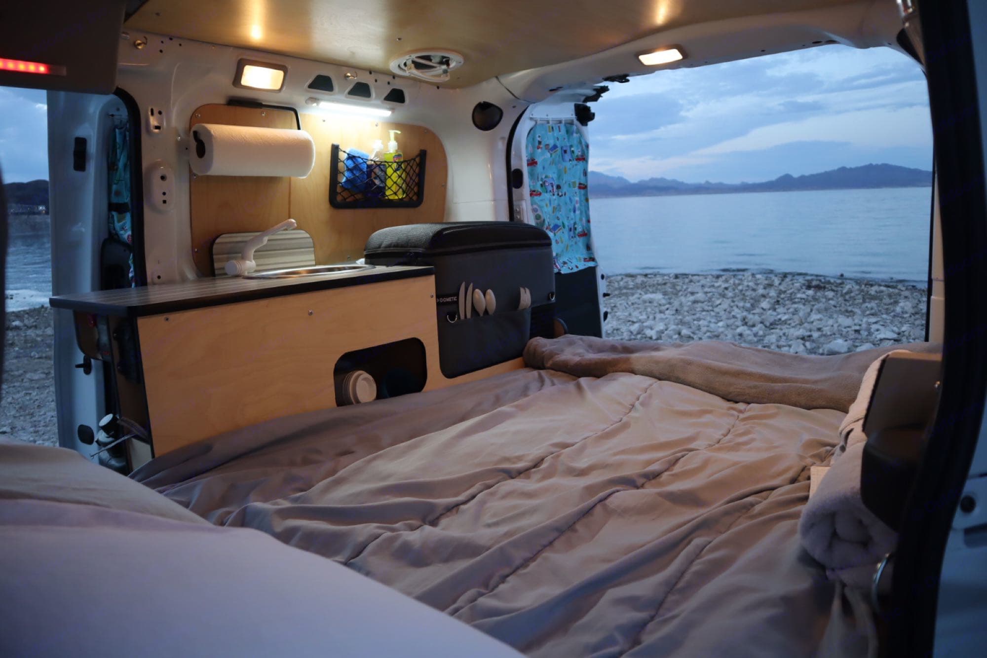 Experience van life in this RV rental! Cozy bed, mini-kitchen, & serene lake view await your next adventure.. Cascade Campers Ram Promaster City 2019