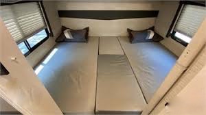 This RV rental features light-colored, comfortable sleeping: two twin beds plus a middle extension for compact travel accommodation.. Thor Motor Coach Four Winds 2020