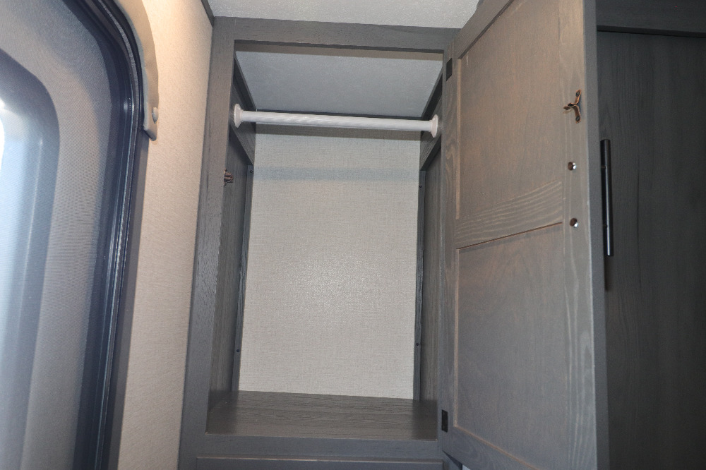 RV rental: Compact gray closet with a white hanging rod for clothes, next to a window with a screen and shade.. Duchmen Aspen trail 2850BHS 2022