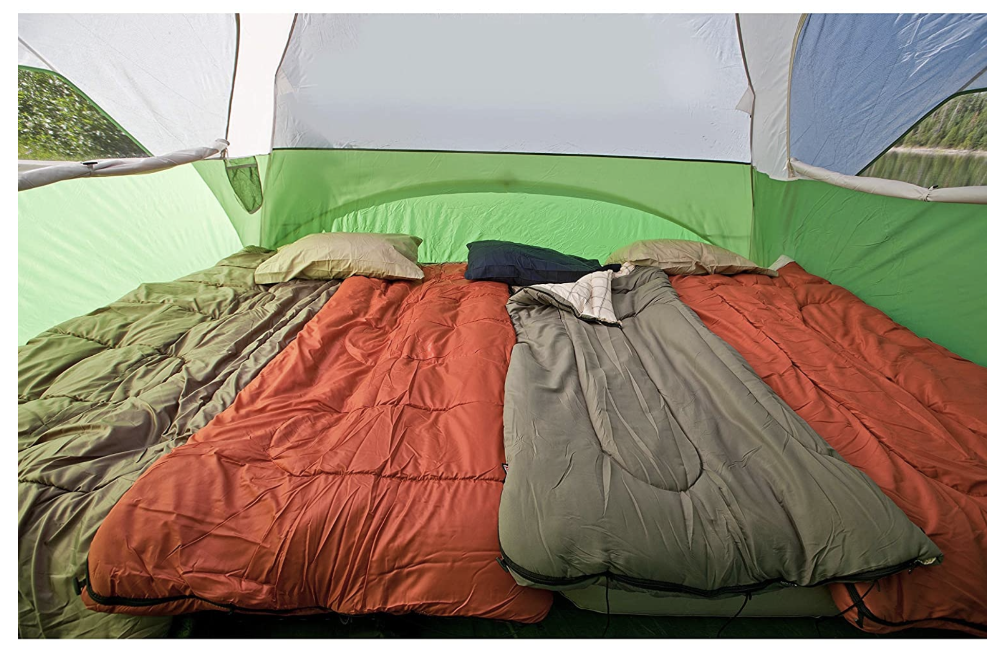 View inside a green and white tent showing three sleeping bags (orange & grey) and pillows, ready for an RV rental camping trip.. Honda Element 2009