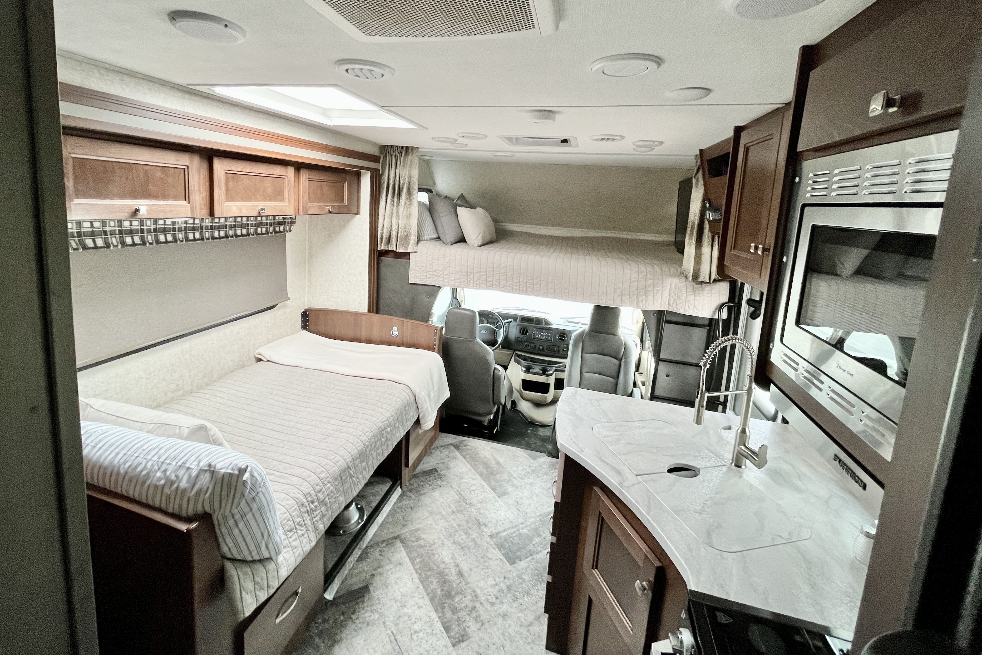 Queen over the cab bunk, and twin dinette bed. Forest River Sunseeker Classic 2020