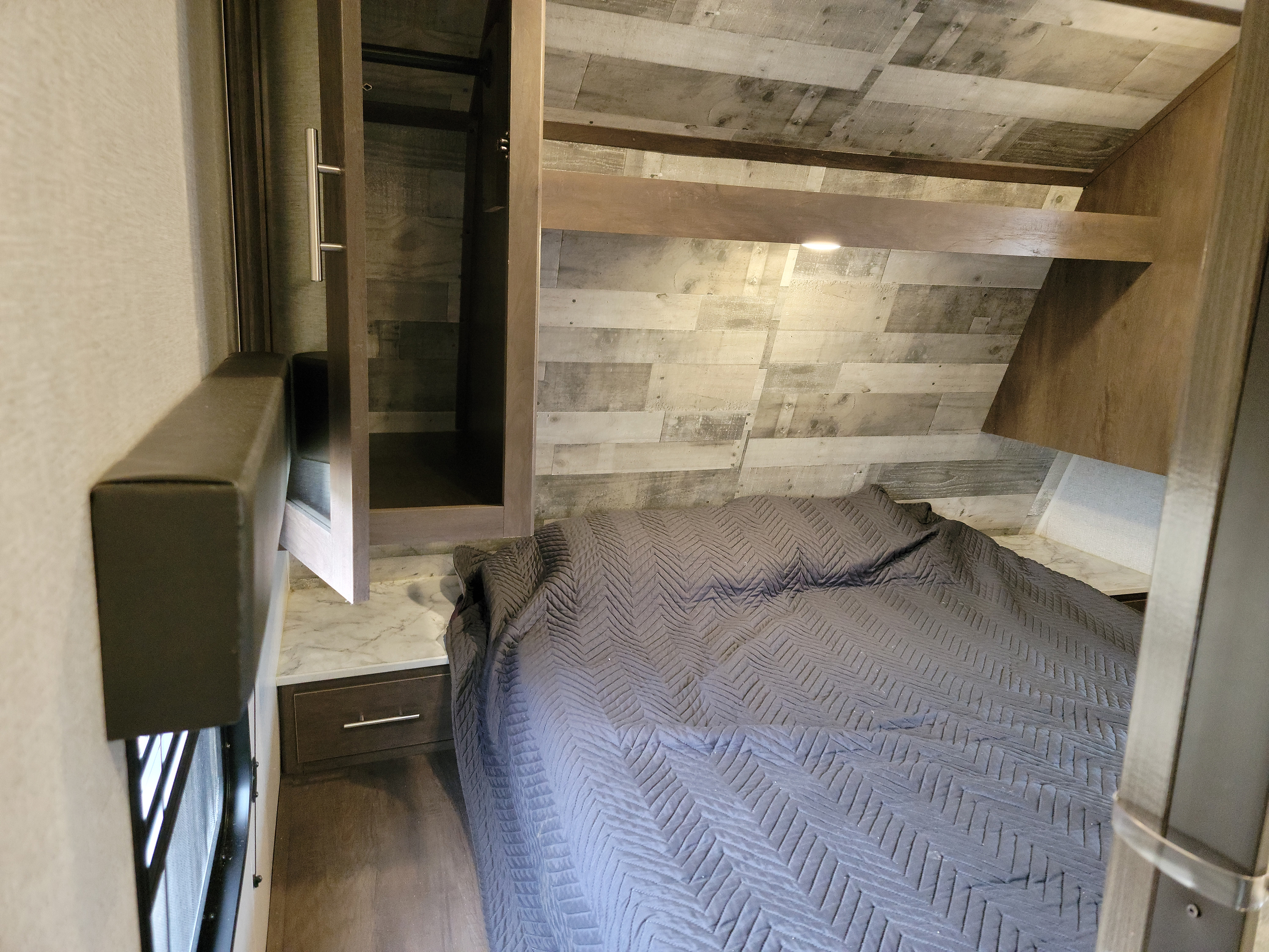 Private bedroom in front of RV. Armoires and night stand on both sides. 12V charging outlets on both sides.. Coleman Lantern 300TQ 2021