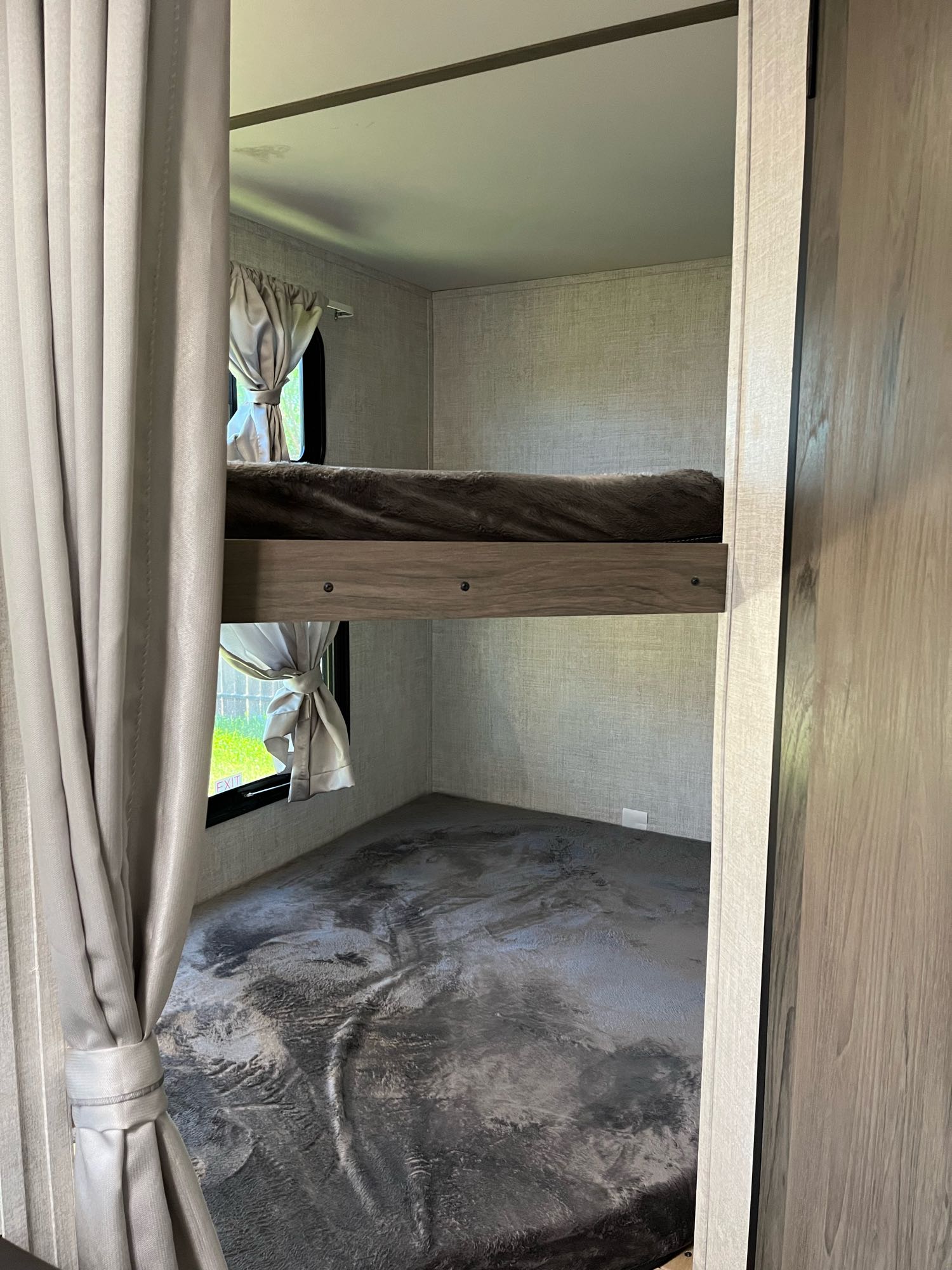 Inside an rv rental: dual bunk beds with curtains & windows offer compact sleeping. Ideal for travel accommodation.. Travel Lite Superlite 2022