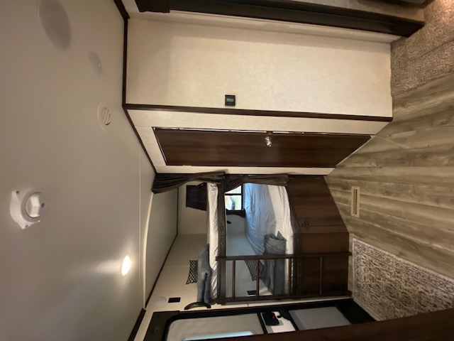 Inside this RV rental: A well-designed loft bedroom, main living area, and storage optimize compact space for travel.. Jayco Jay Flight 2020