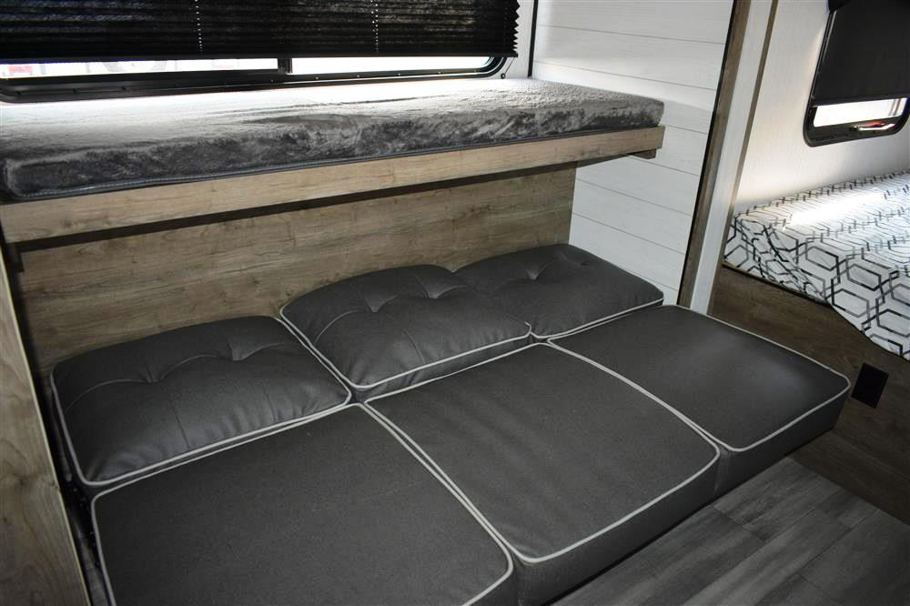 RV rental interior with cozy bunk beds & versatile seating. Perfect for comfortable travel, offering compact sleeping & lounge space.. Other Pioneer 2022