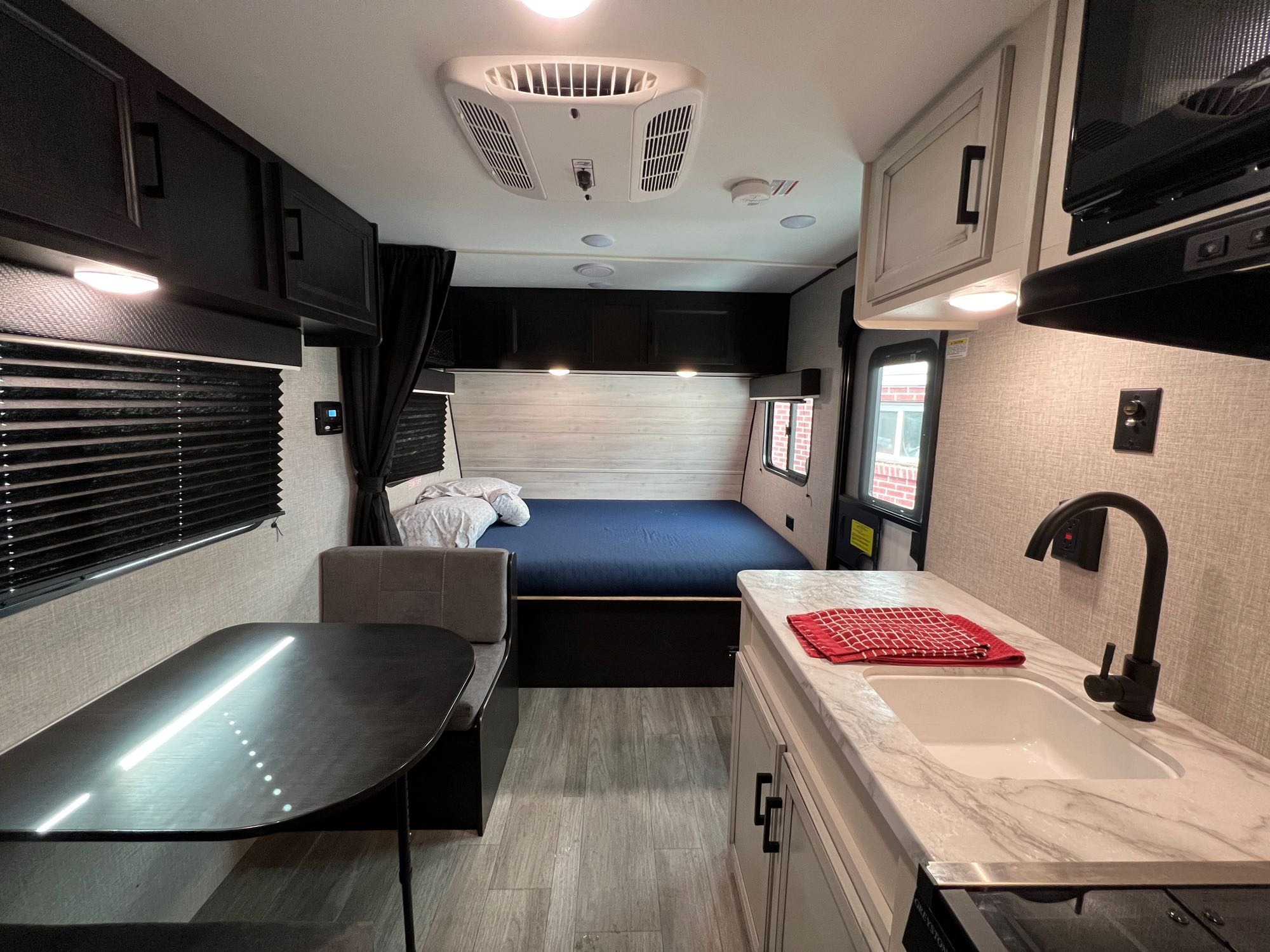 Spacious RV rental interior with a cozy bed, dinette, and fully equipped kitchen. Perfect for your next adventure!. Jayco Jay Flight 2022