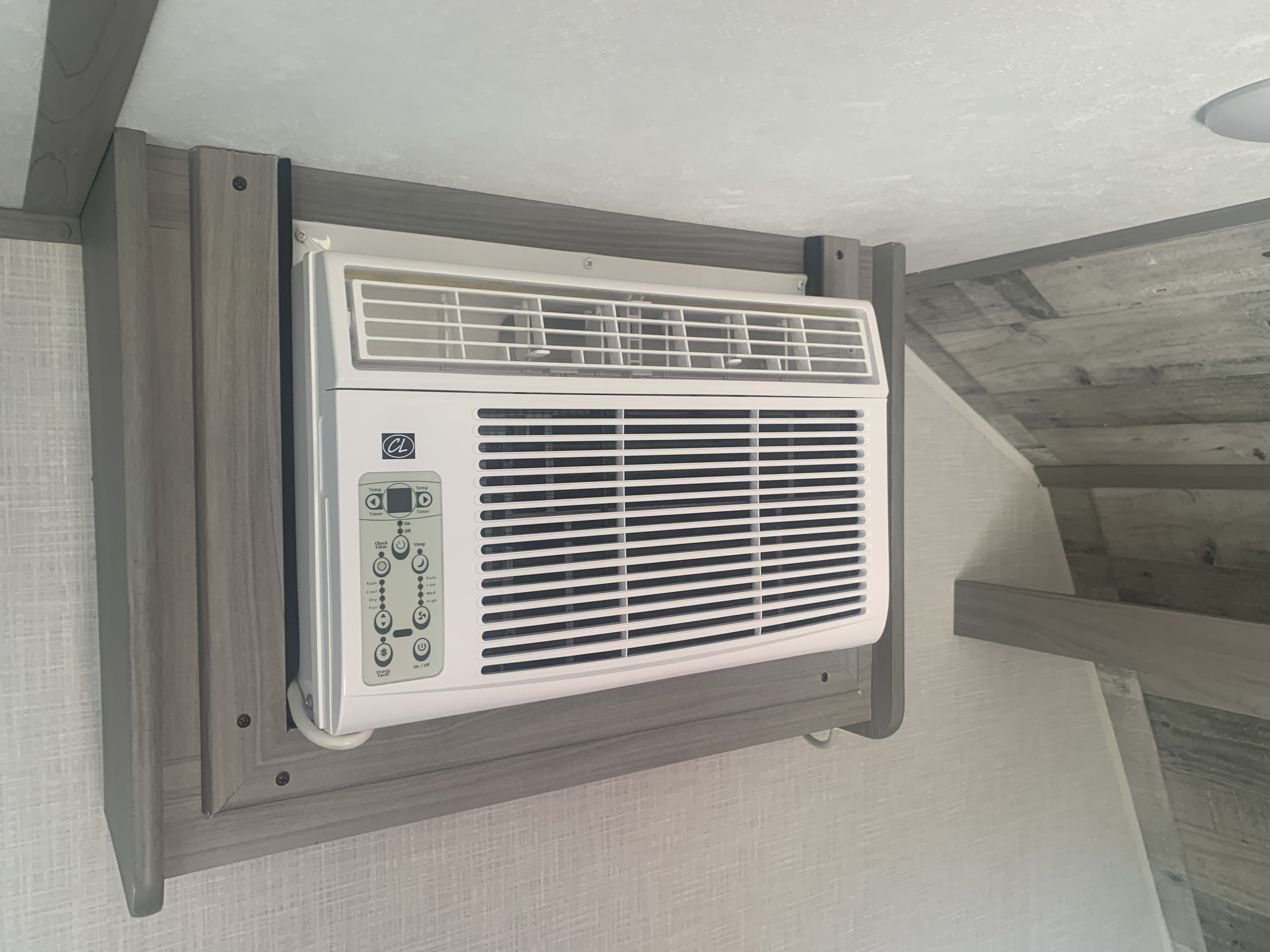 Wall-mounted air conditioner unit installed in an RV rental, providing essential cooling for travelers.. Coleman 17B 2022