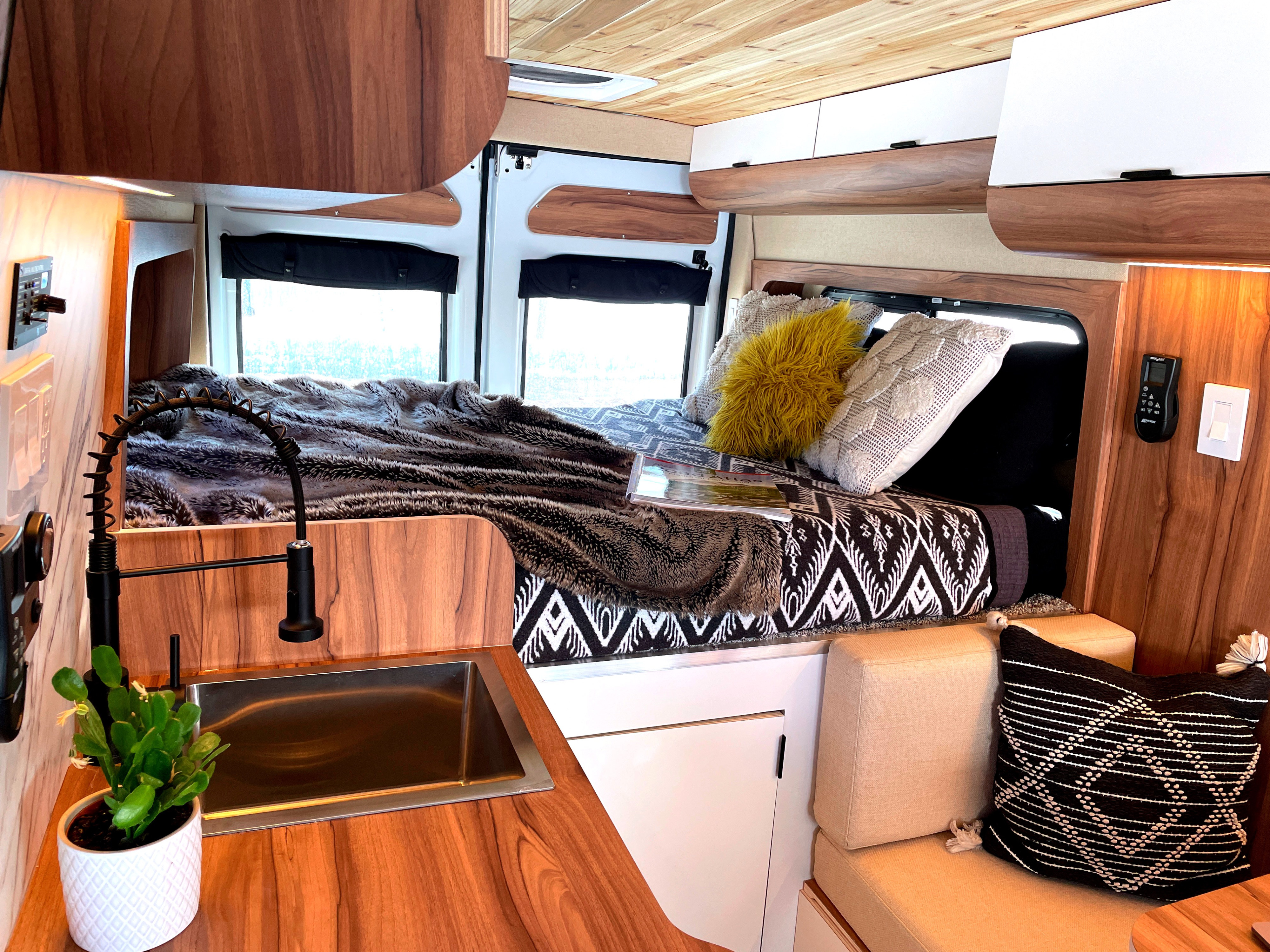 This RV rental offers a compact yet complete interior with a bed, kitchen, seating, and ample storage for travel.. Ram Promaster 2021