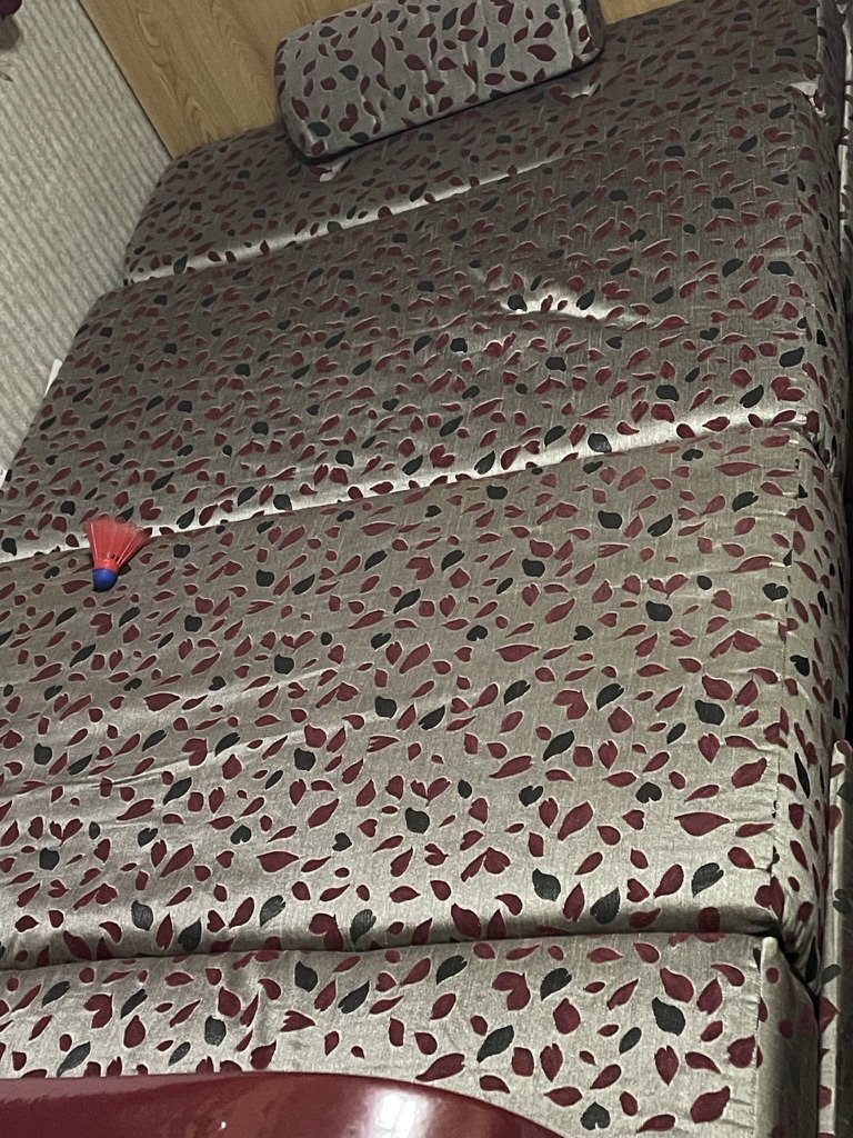 Cozy patterned bed in RV rental, with bolster pillow. Ideal for comfortable rest after your adventures.. R-Vision Trail-Lite 2001