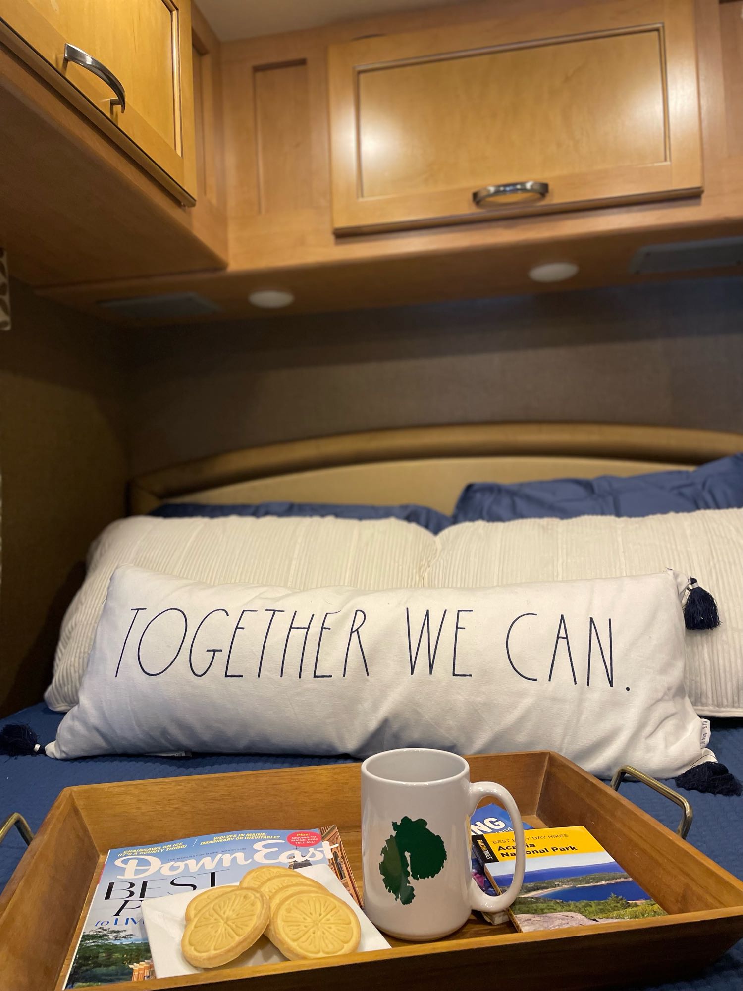 Cozy RV rental bedroom scene: breakfast in bed with Maine mag, cookies, guide, and "TOGETHER WE CAN" pillow.. Thor Four Winds 2017