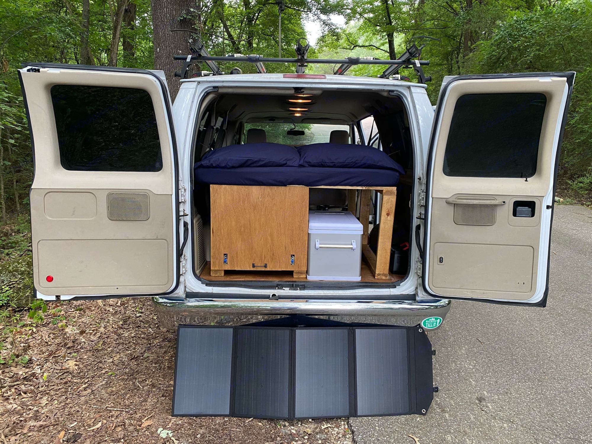 Spacious RV rental, perfect for road trips! Features a bed, storage, and a portable solar panel for off-grid adventures.. Ford Econoline 2012