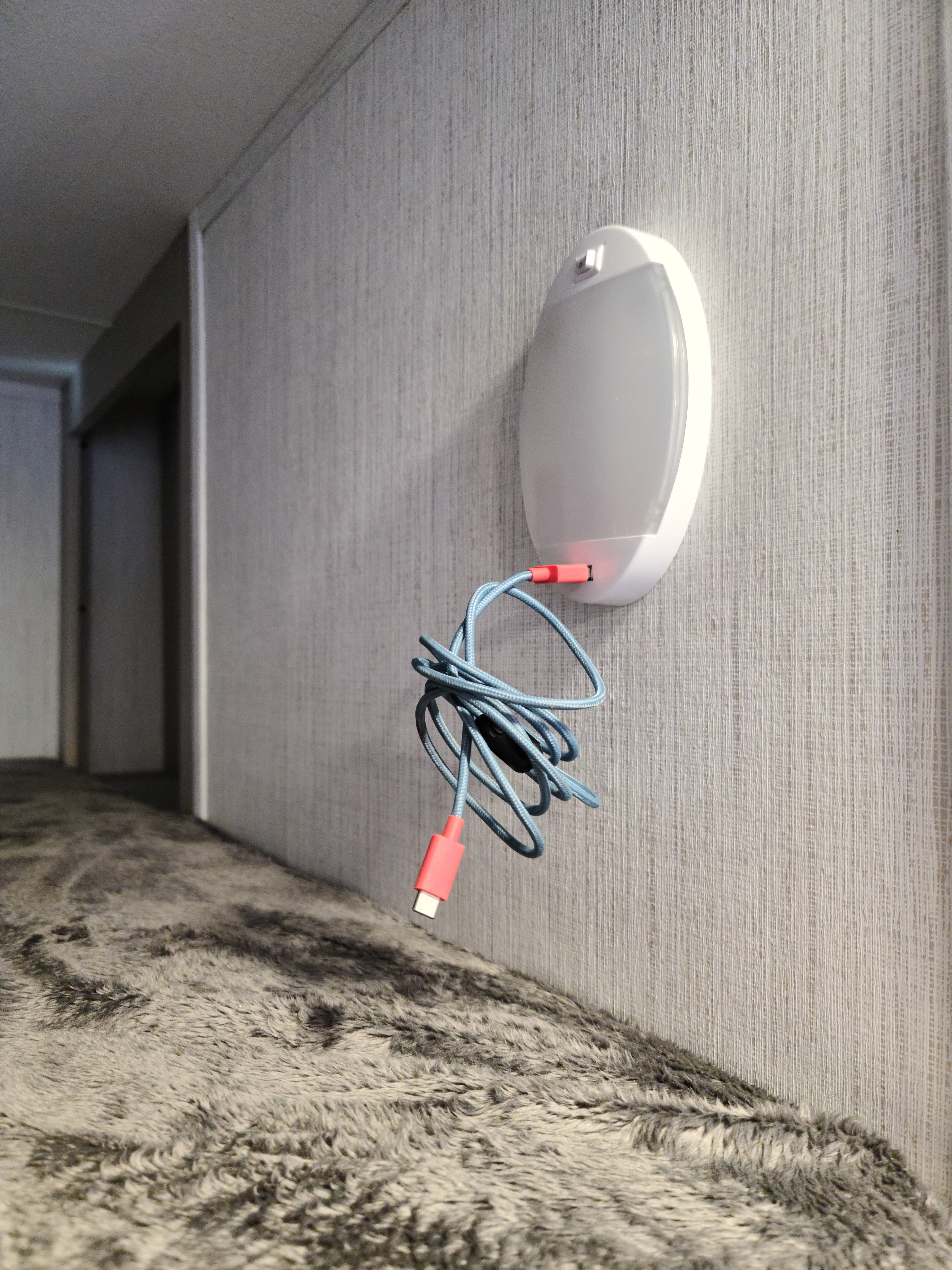 Cozy RV rental bunk area features a wall-mounted USB charger with a blue braided cable & soft grey faux-fur bedding.. Heartland mallard 2022