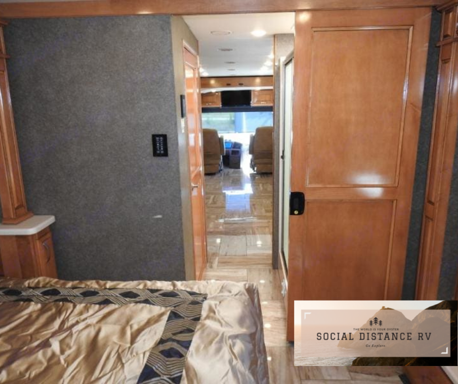 Spacious RV rental interior: bedroom view looking down a luxurious hallway to the driver's cab.. Thor Motor Coach Venetian 2017
