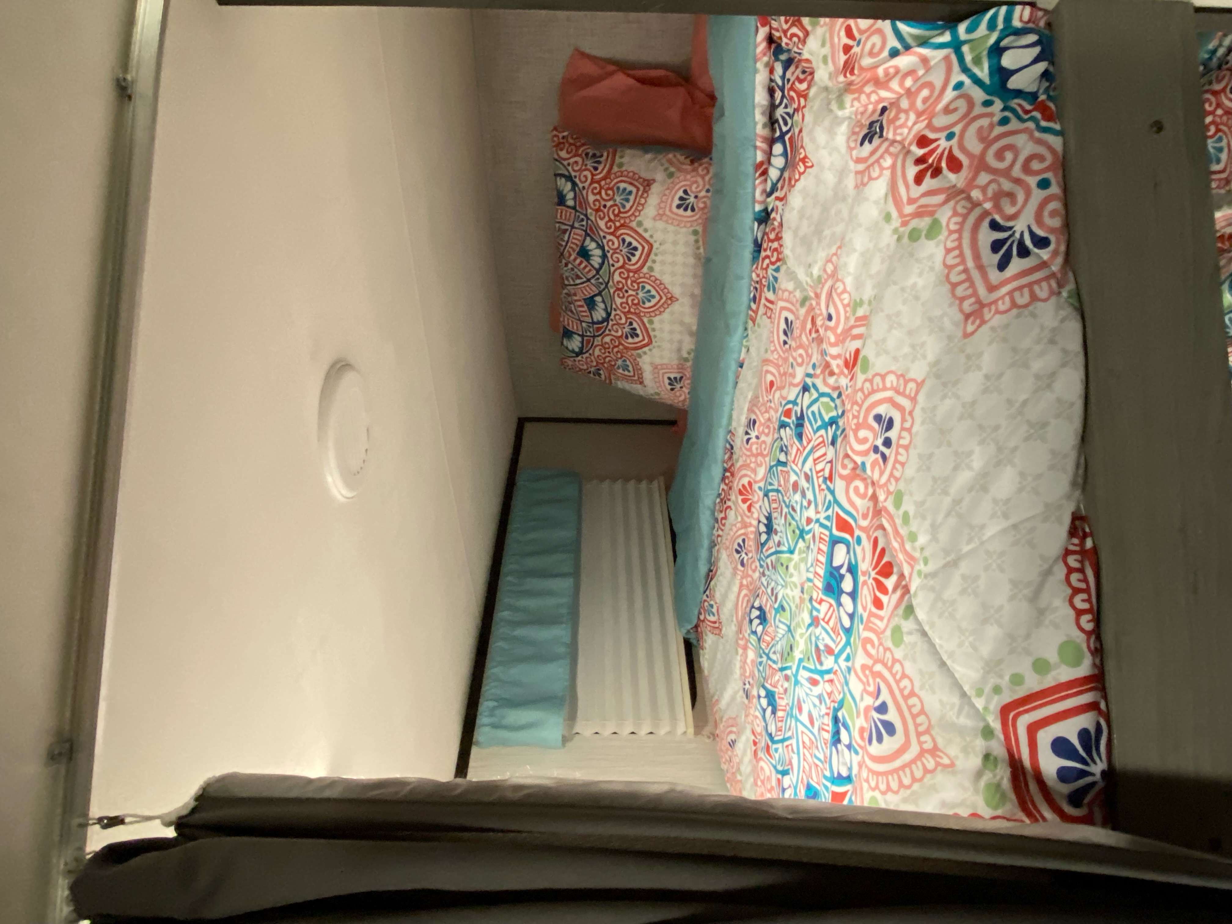 Cozy RV rental bedroom featuring two bunks with vibrant, patterned comforters.. Heartland RVs Mallard 2021