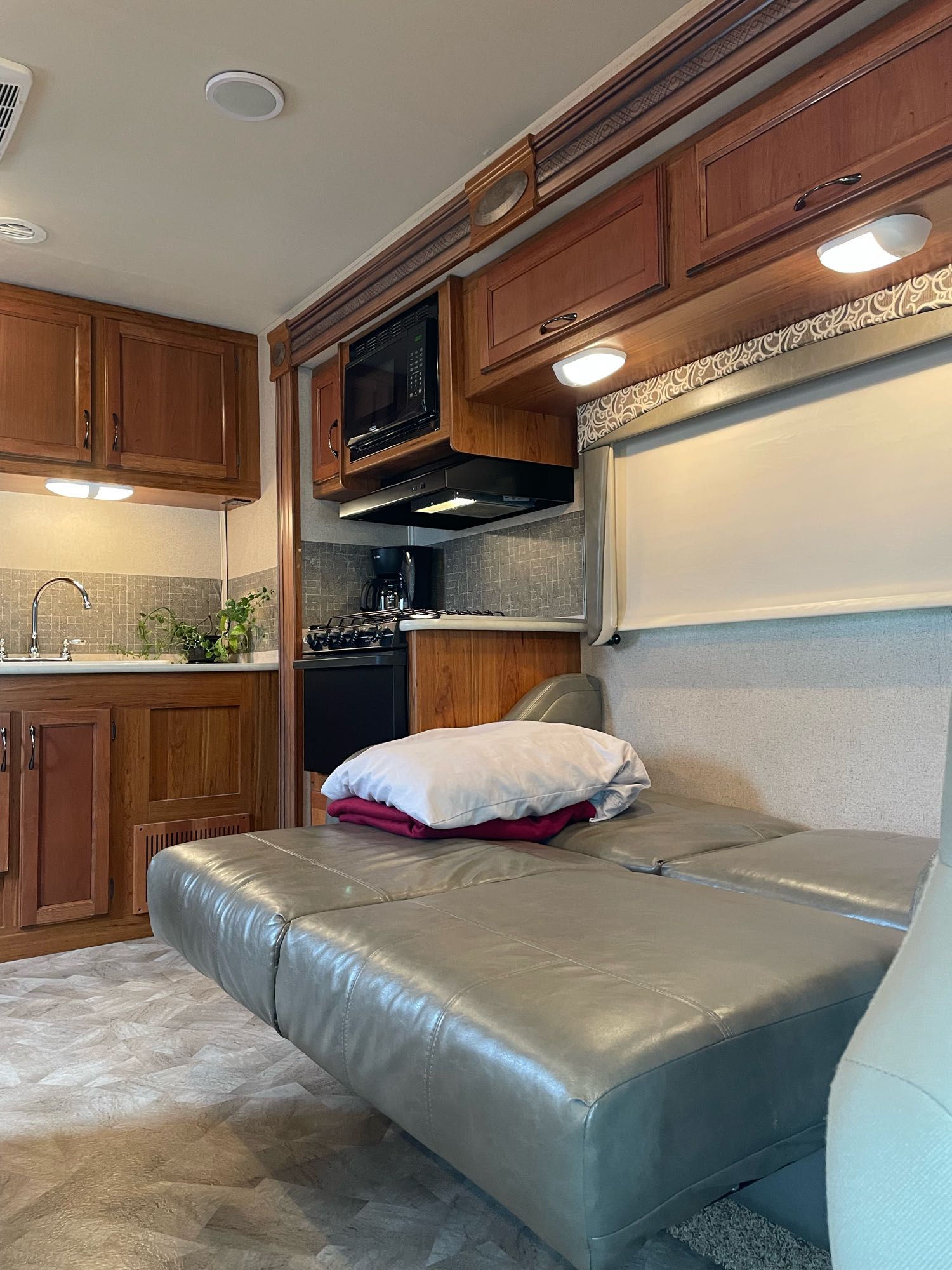 RV rental interior: A functional kitchen, comfortable sofa/bed, and ample storage, ideal for compact travel.. Jayco Redhawk 2016