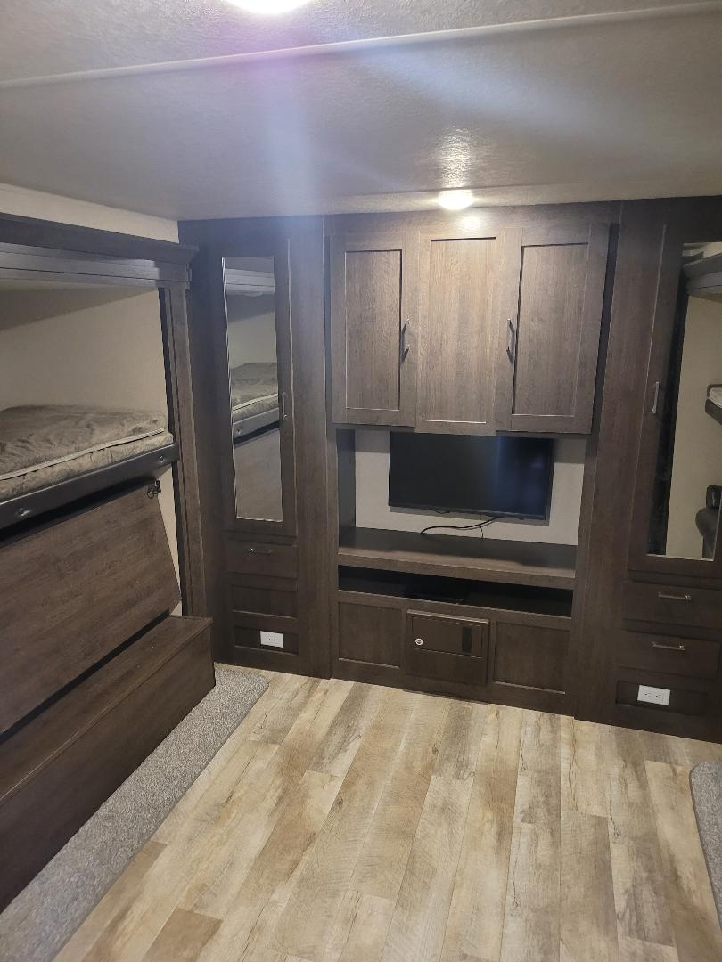 RV rental interior: bunk beds, entertainment unit with TV, and built-in storage. Ideal for family adventures.. Forest River Salem 2018