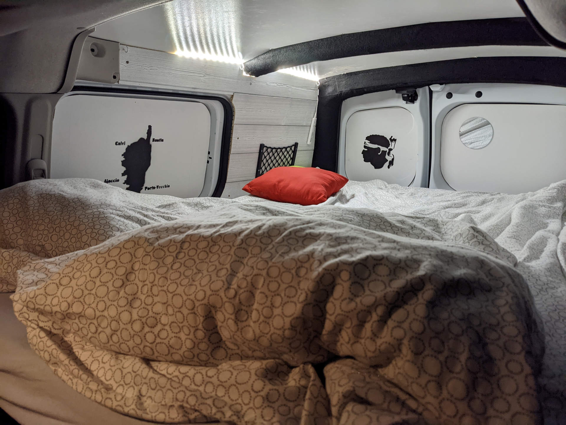 Cozy camper van bed with Corsican map & flag art, illuminated by LEDs. Great for an RV rental road trip.. Renault Kangoo 2018