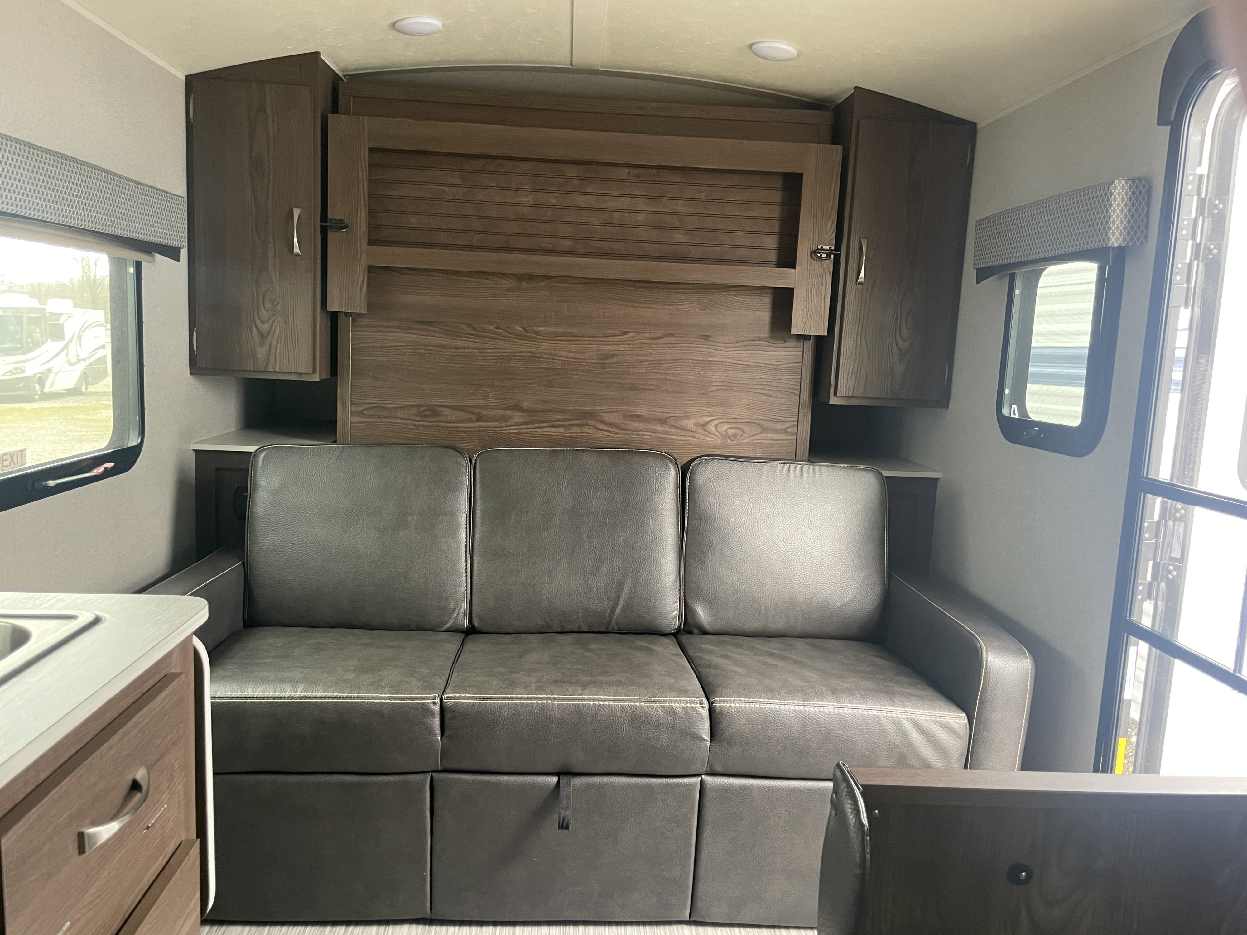 RV rental: Cozy interior featuring a sofa, fold-down bed, overhead storage, and windows.. Forest River GeoPro 2018