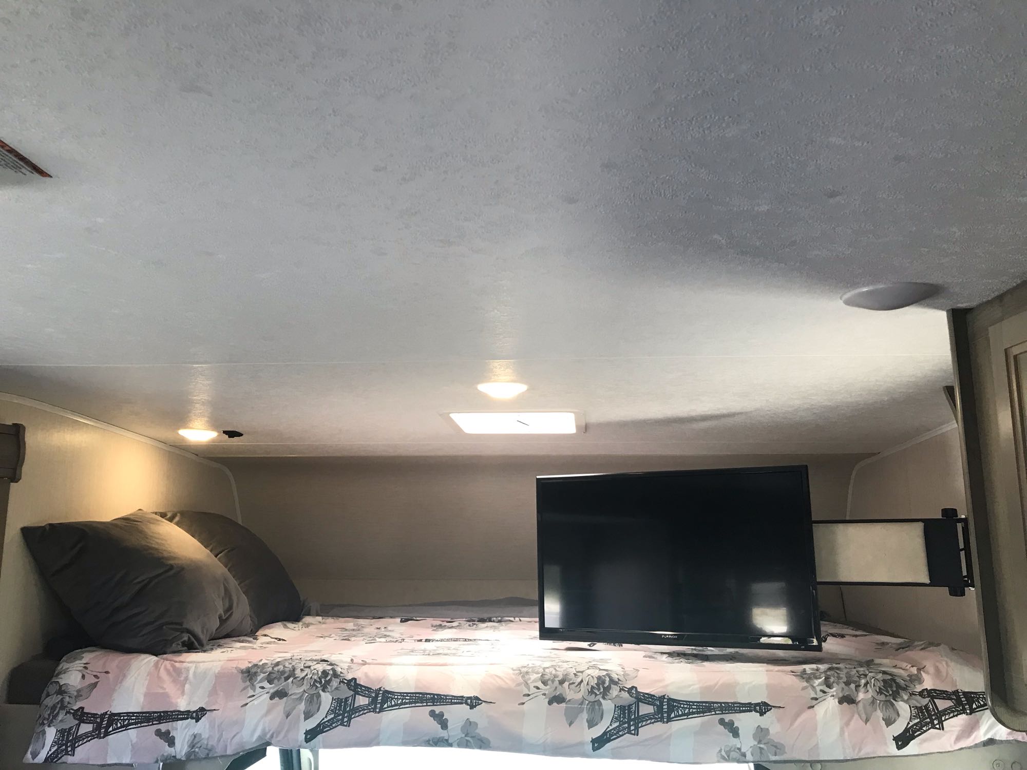 Sleep soundly in this RV rental's over-cab bed with a TV, perfect for a relaxing getaway.. Forest River Coachmen Freelander 2019