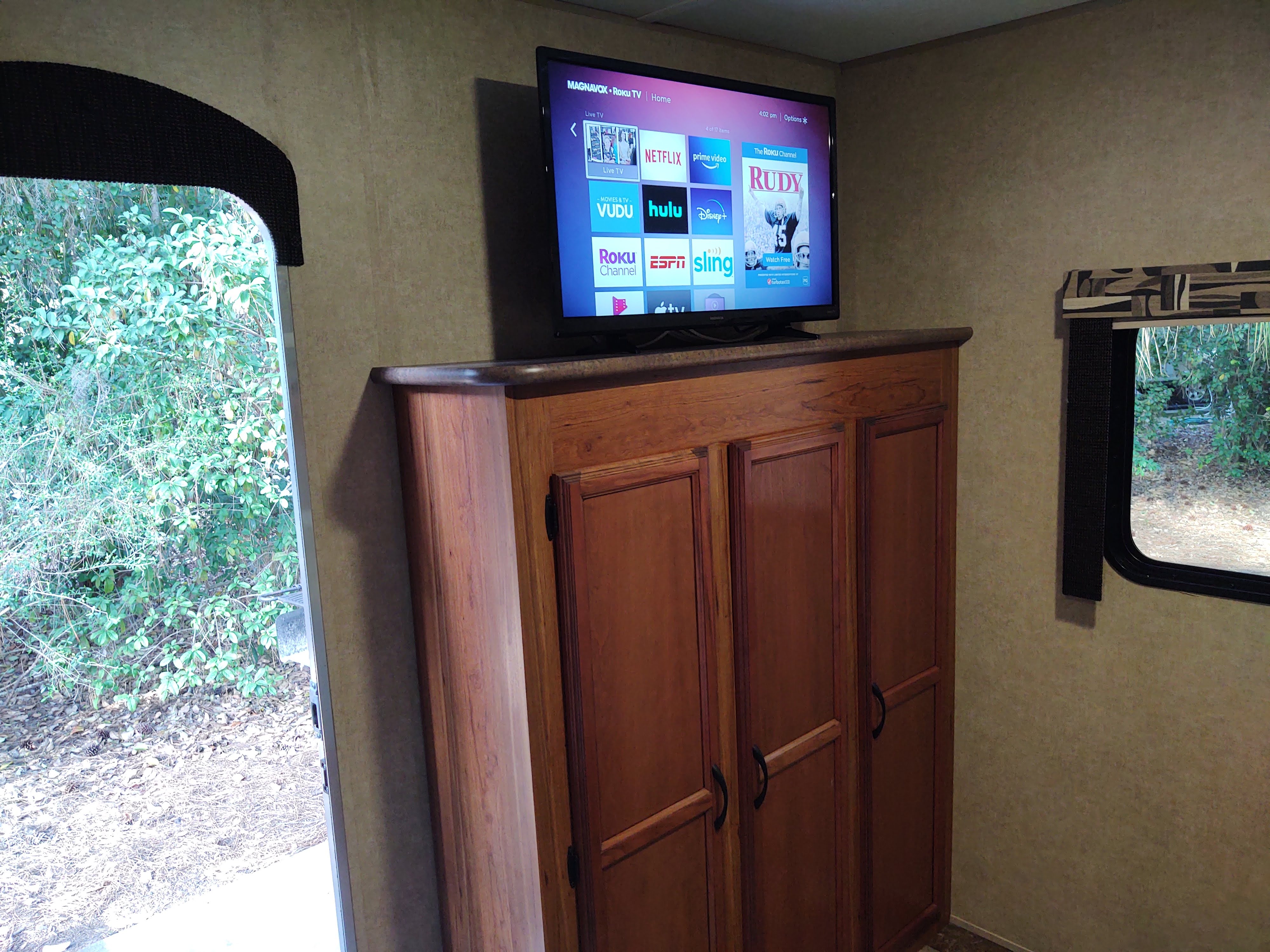 Cozy RV rental interior with a Roku TV ready for streaming entertainment, offering a view of lush nature outside.. Starcraft AR-One Maxx 2016