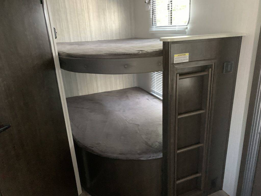 RV rental: Interior shot of stacked bunk beds with grey mattresses and a built-in ladder, perfect for family trips.. Heartland RVs Pioneer 2018